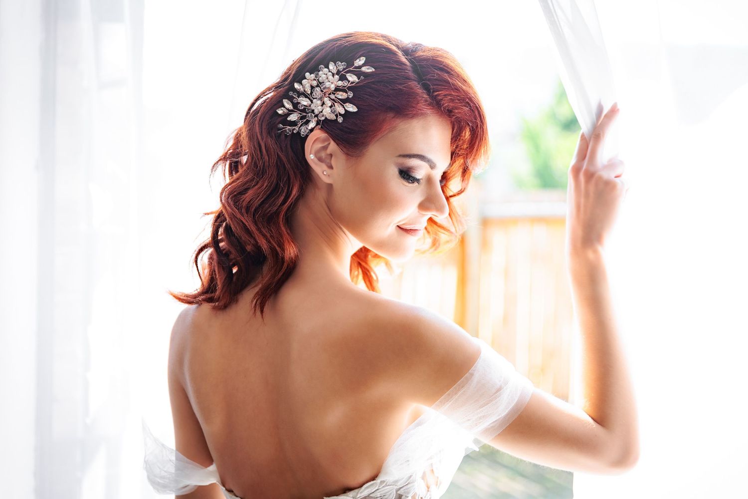 Elegant bridal portrait with lace details and soft window lighting.