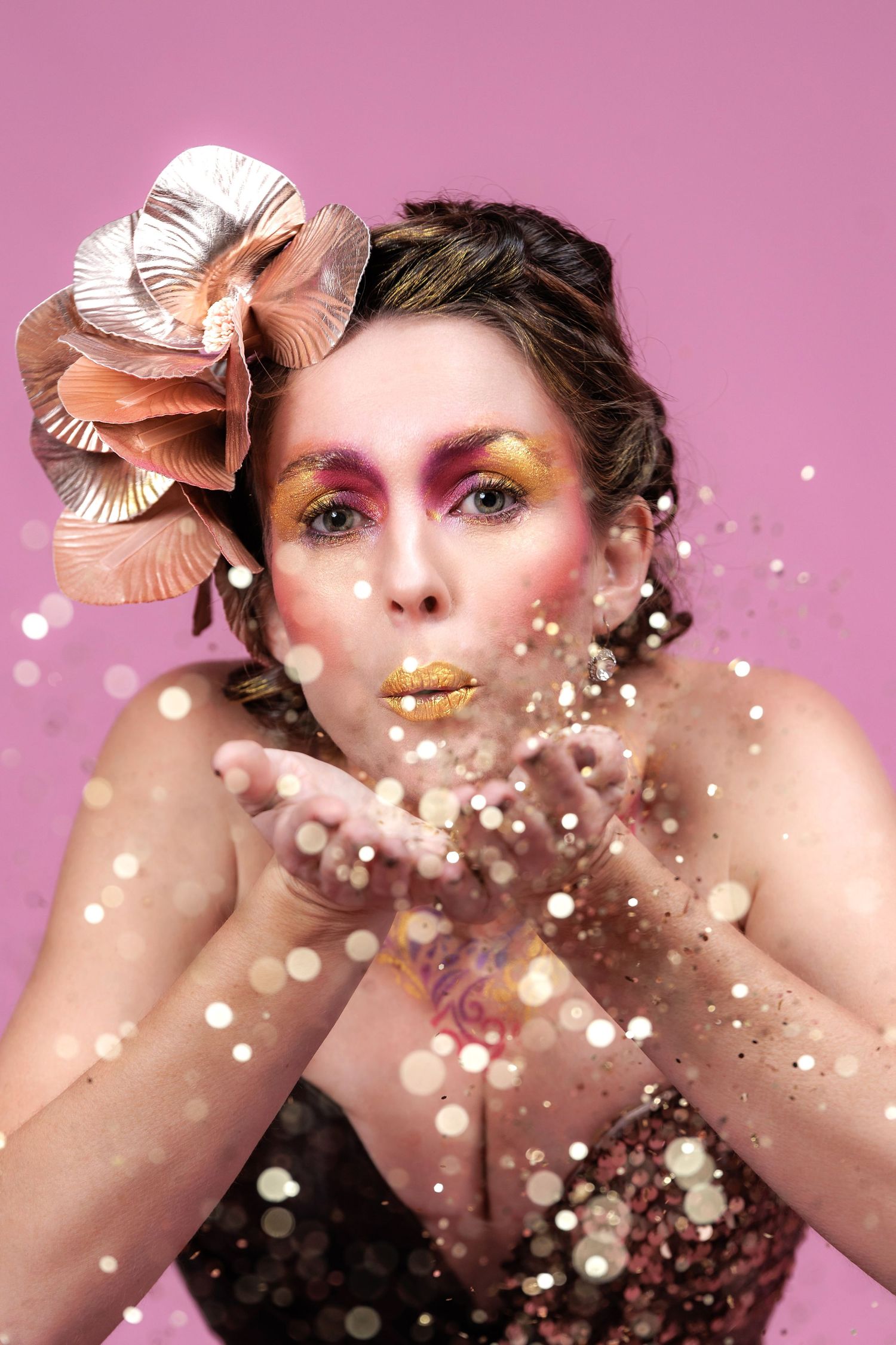 Artistic beauty portrait with glittery gold makeup and sparkles against pink background in sequence.