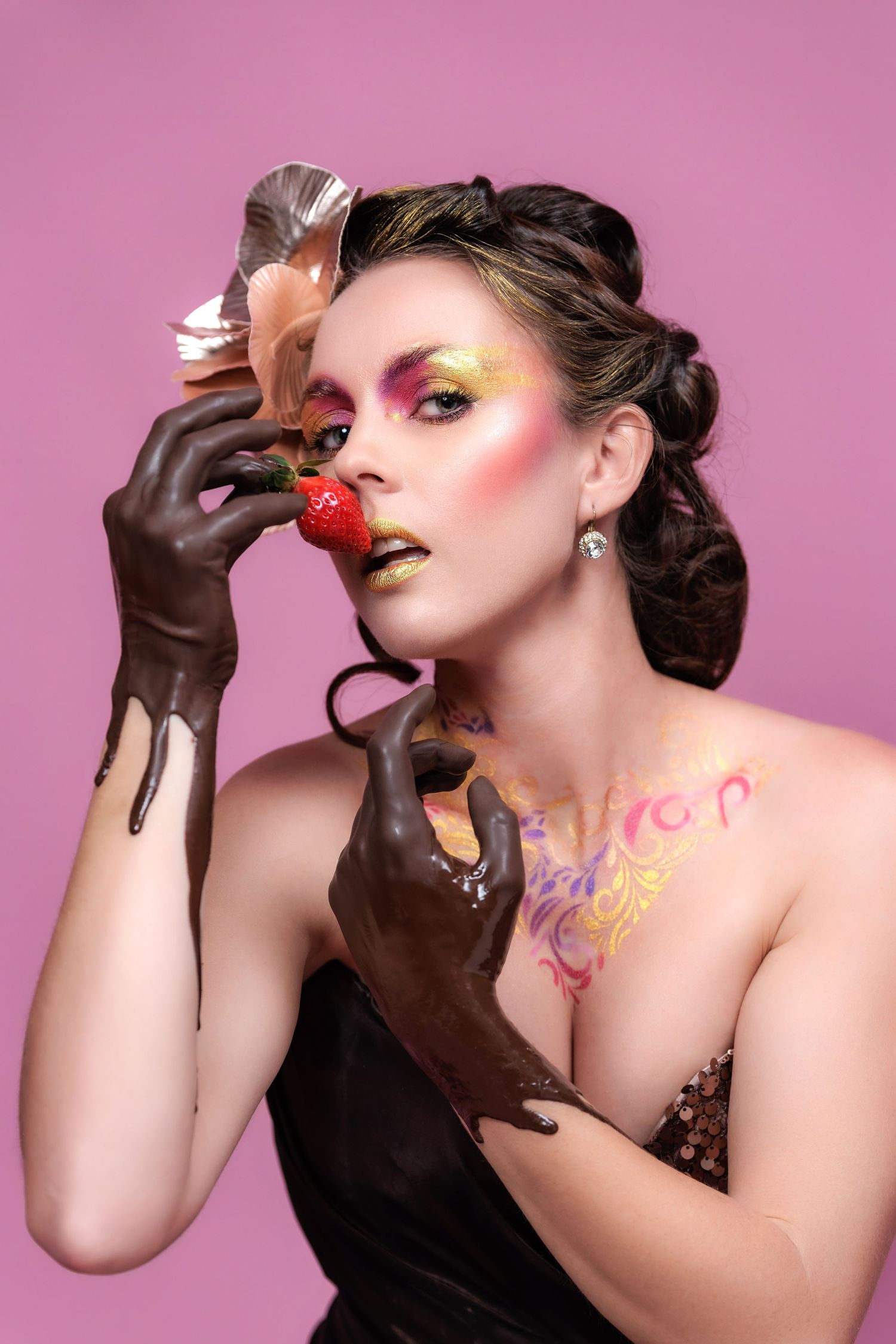 Artistic fashion photo series showing model eating chocolate covered strawberries against pink background.