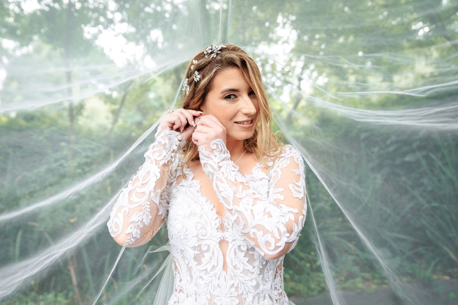 Ethereal bridal portraits through sheer veil in outdoor garden setting.