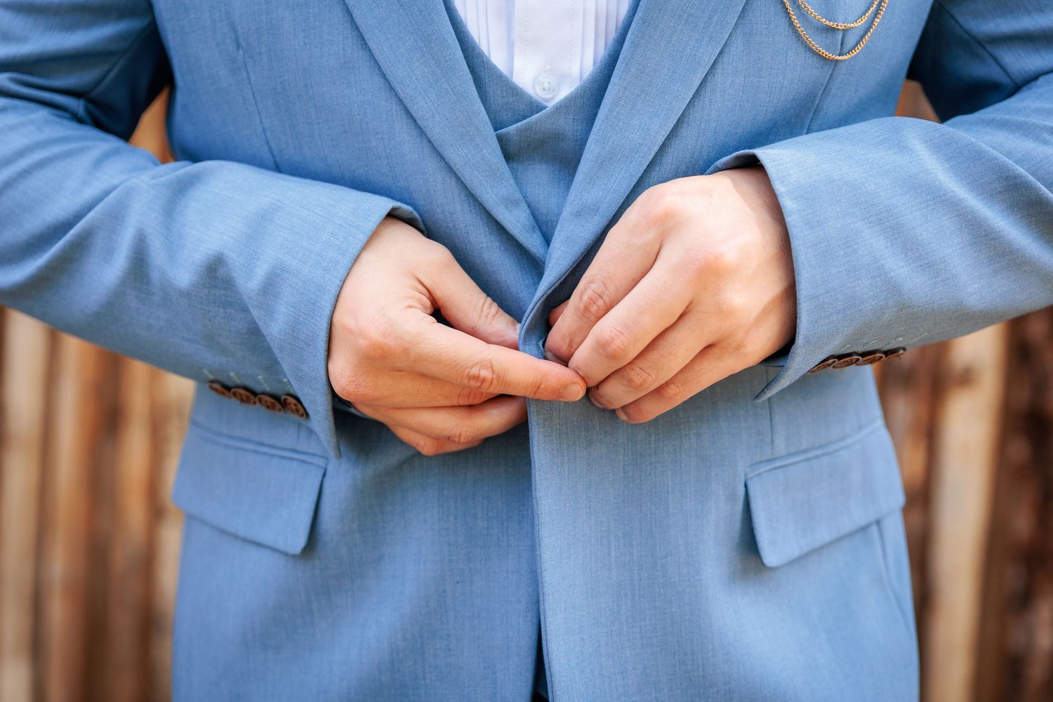 Detail shot of light blue wedding suits with classic tailoring.