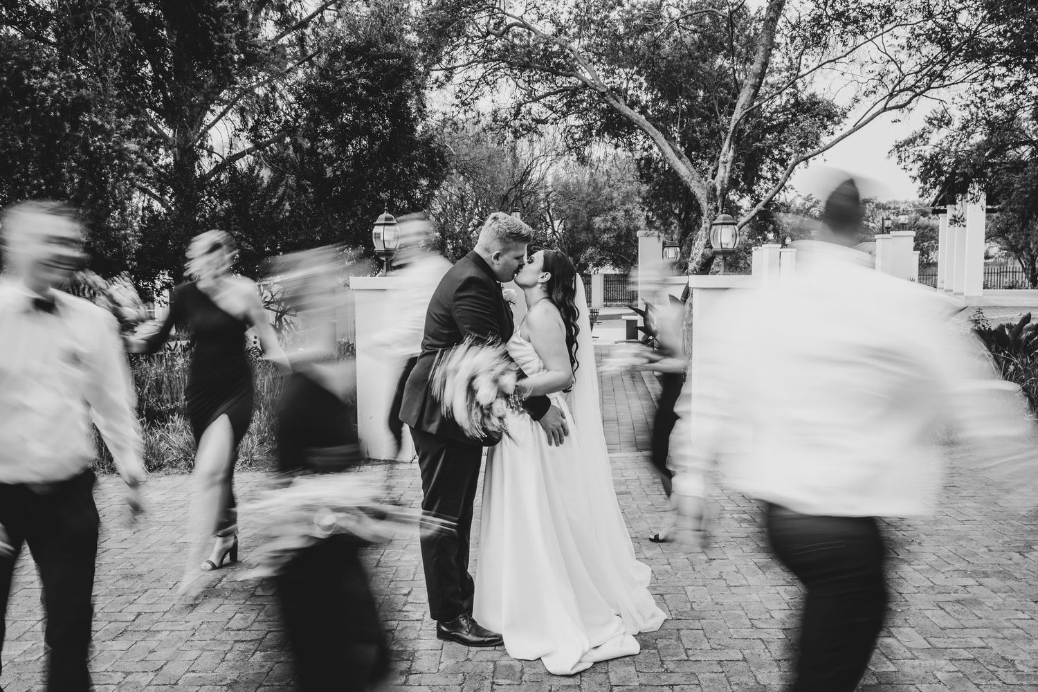 Black and white motion blur photos of wedding party dancing.