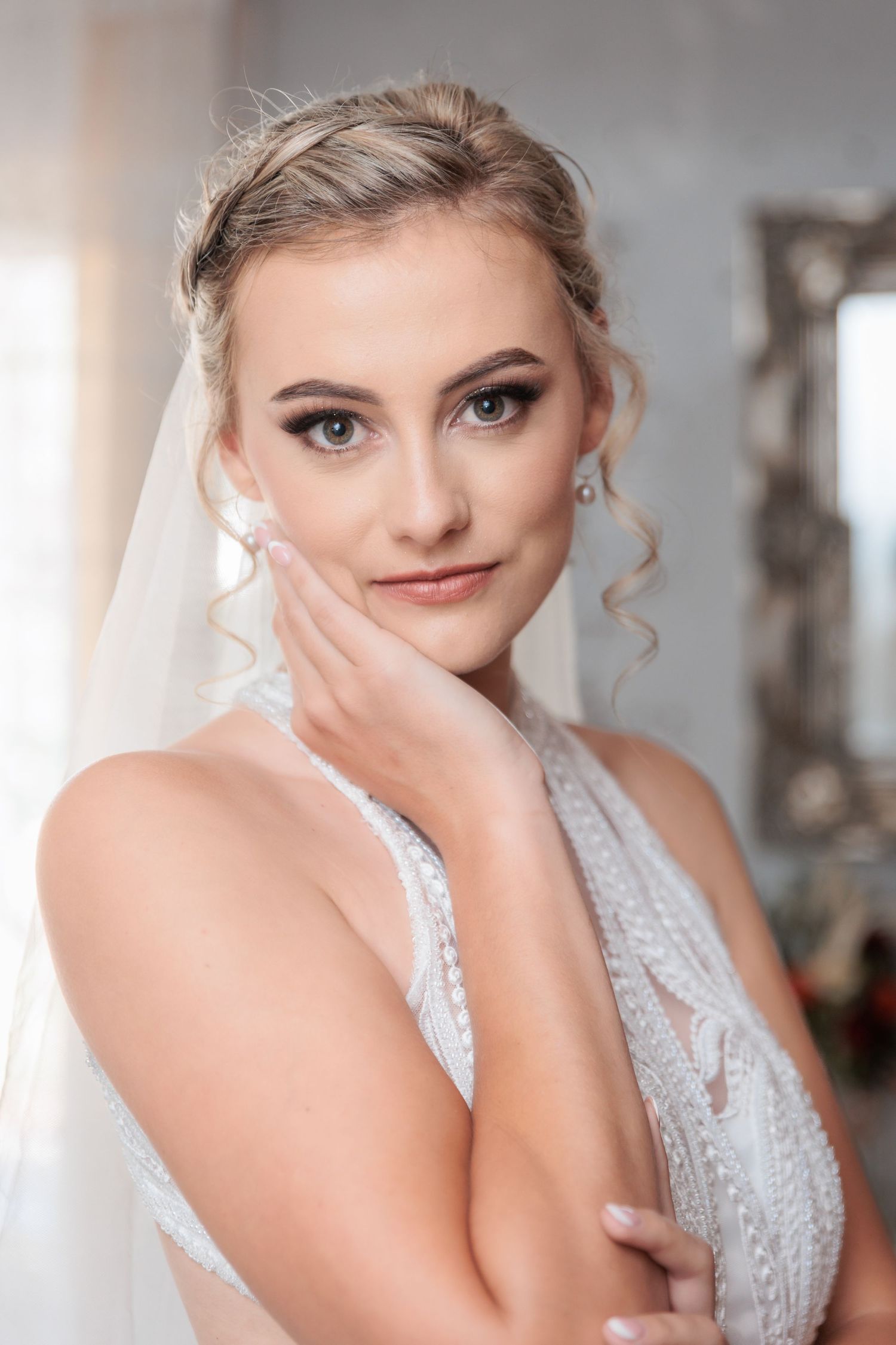 An elegant bridal portrait showcasing delicate lace details and sophisticated makeup.