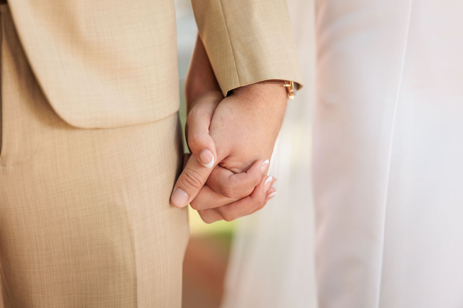 An intimate capture of a couple holding hands during their wedding ceremony.