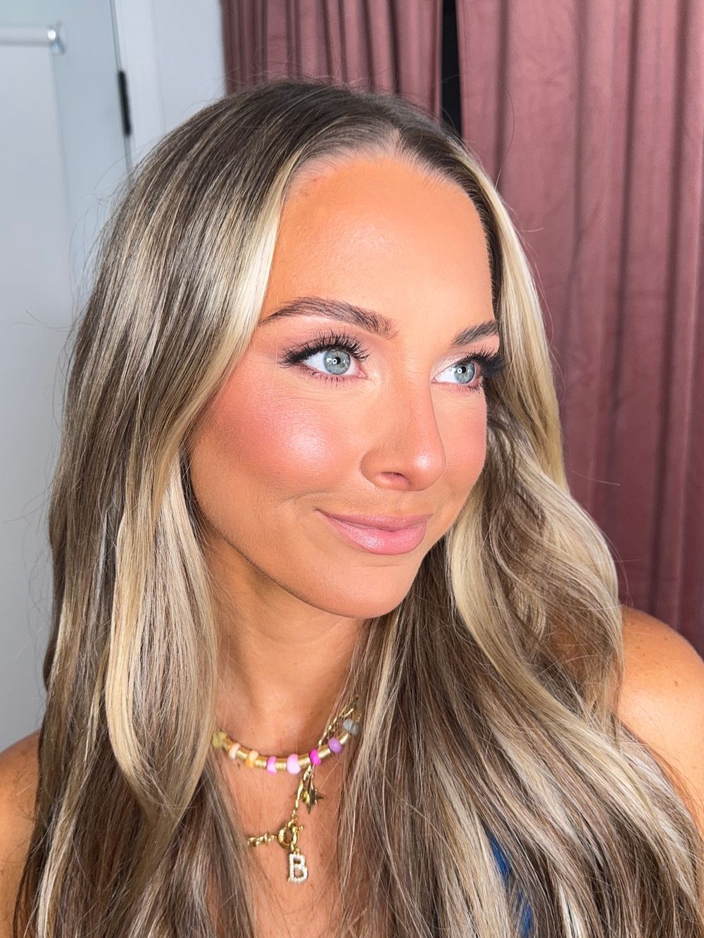 Beauty shots showcasing blonde balayage hair, glam makeup and delicate gold jewelry.