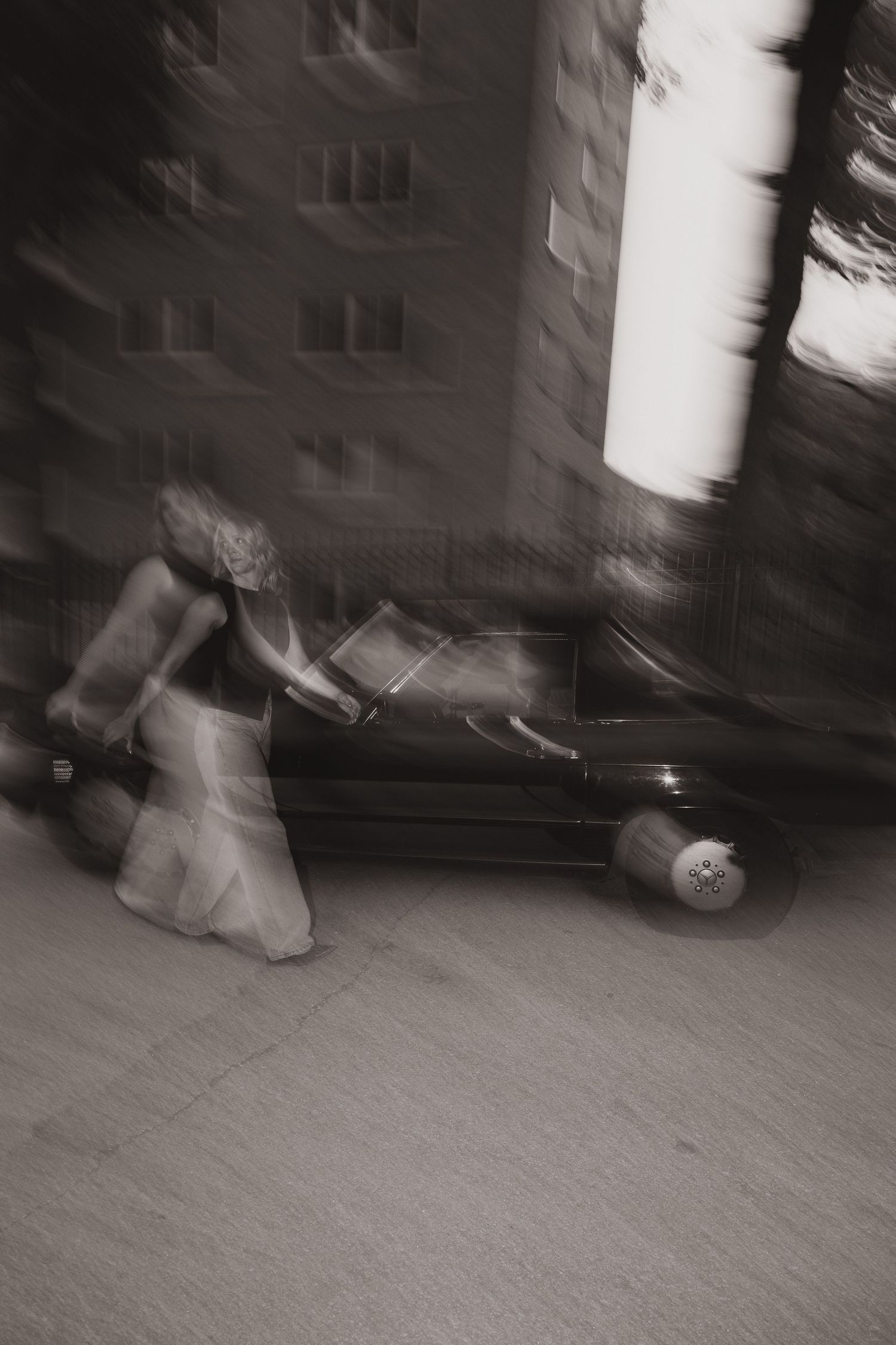 Blurred monochrome sequence capturing movement and shadows in an indoor space.