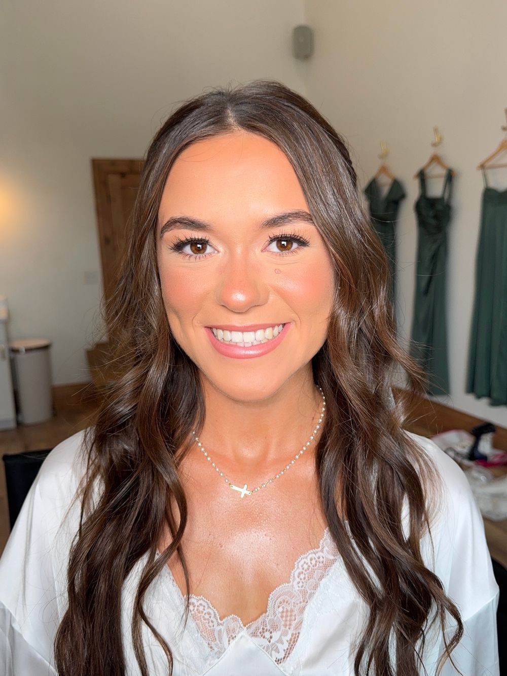 Indoor bridal portraits featuring white lace dress and natural glam makeup.