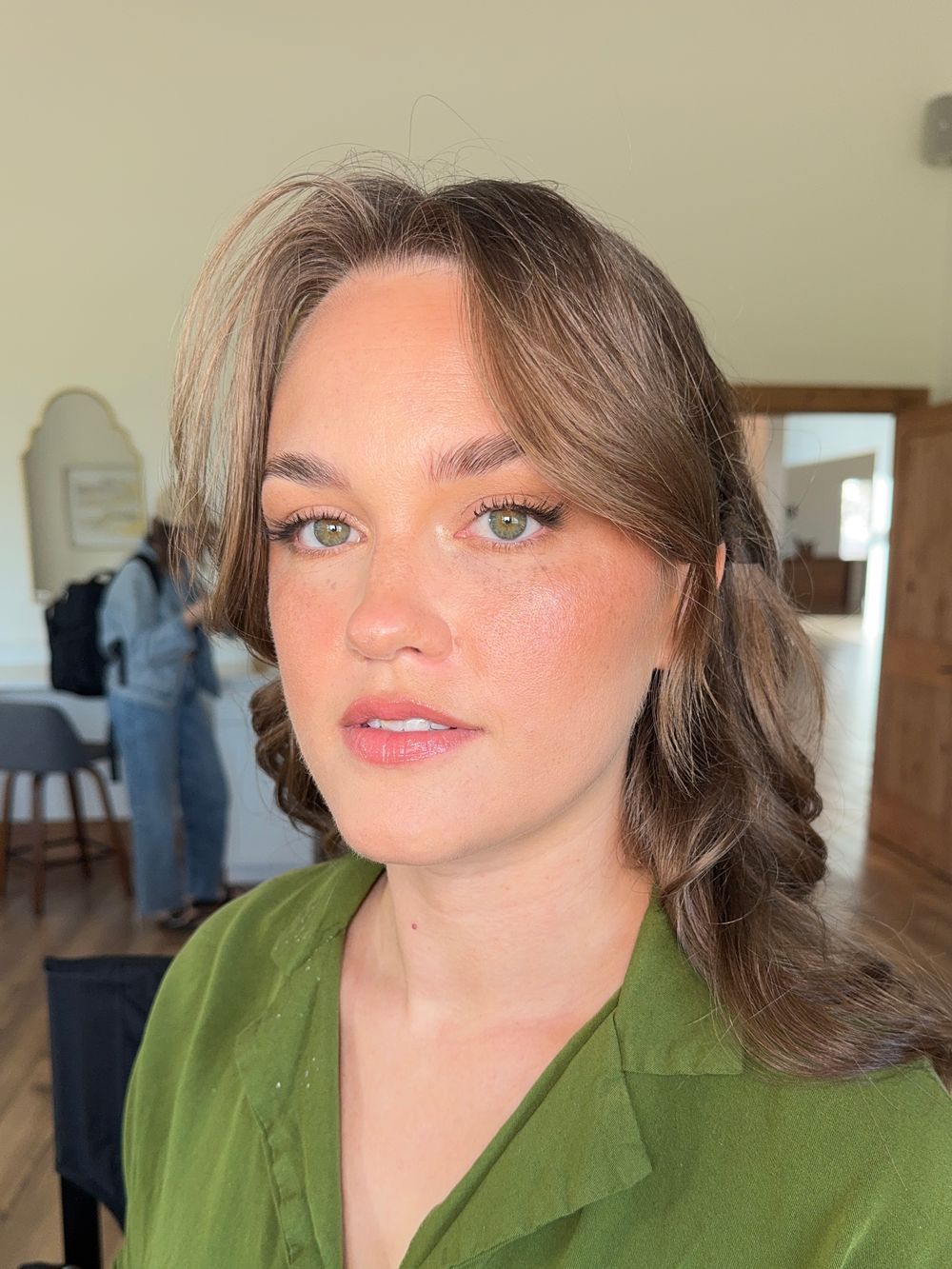 Casual beauty shots in an olive green blazer with natural makeup and styled waves.