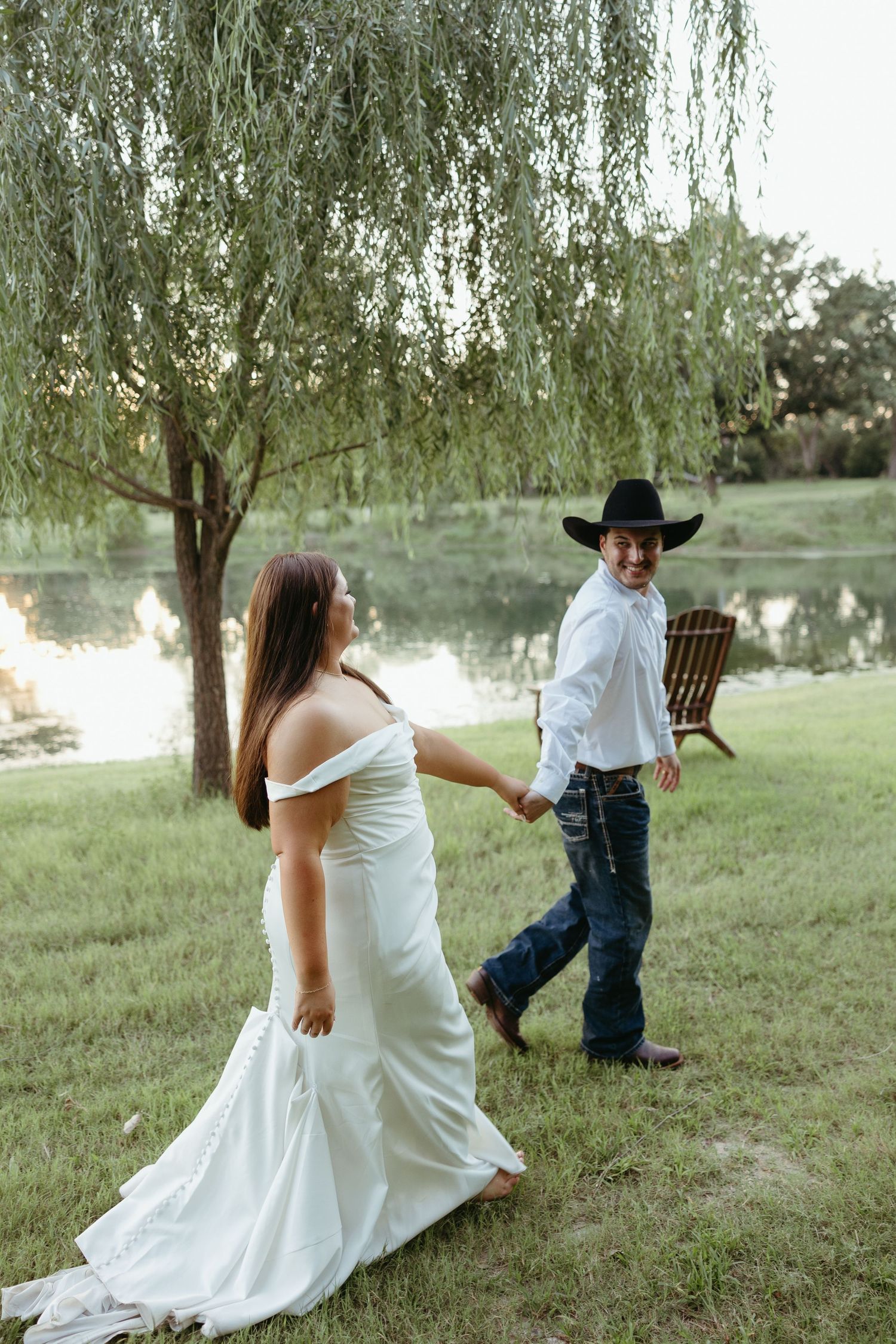 Playful wedding photo sequence under a willow tree in a grassy field.