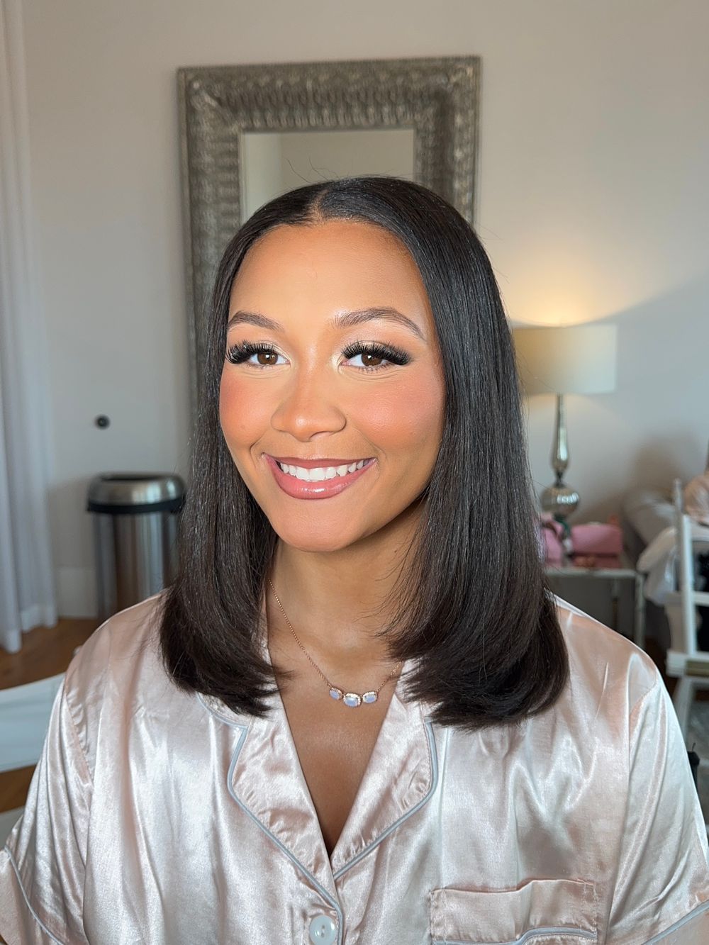 Bridal getting ready photos showing professional makeup and silk robe.