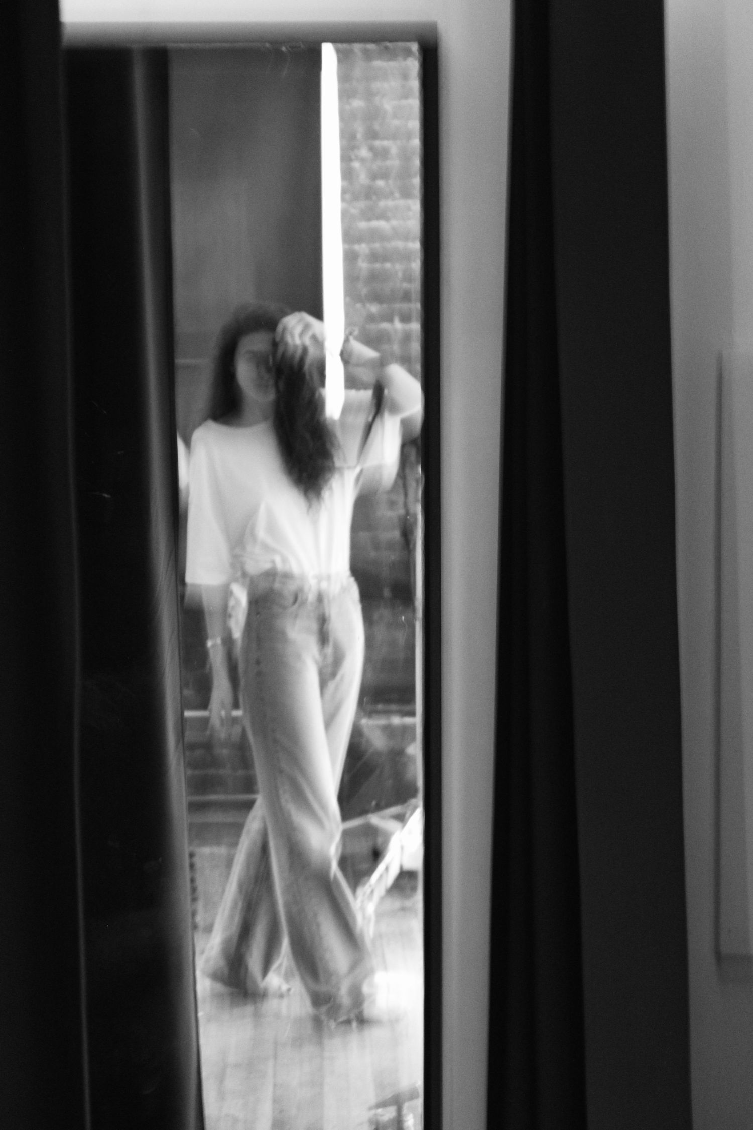 Black and white portrait of Laura Goubault holding a camera