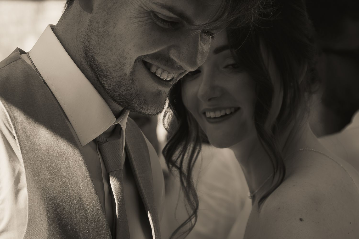 Black and white candid portrait of a smiling bride and groom during their wedding