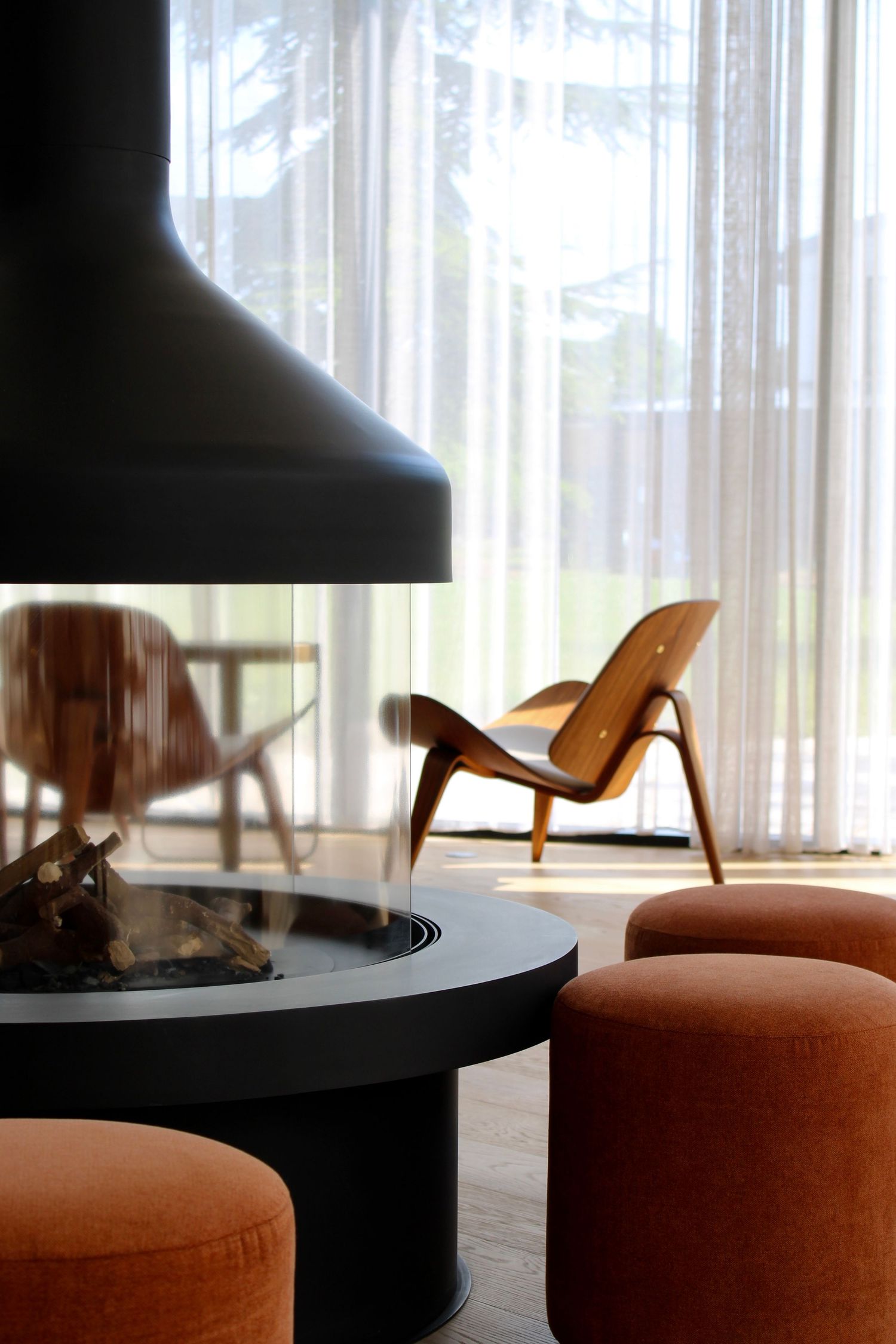 Warm and inviting lobby at Paxton MLV Hotel featuring a fireplace, velvet armchairs and contemporary design furniture