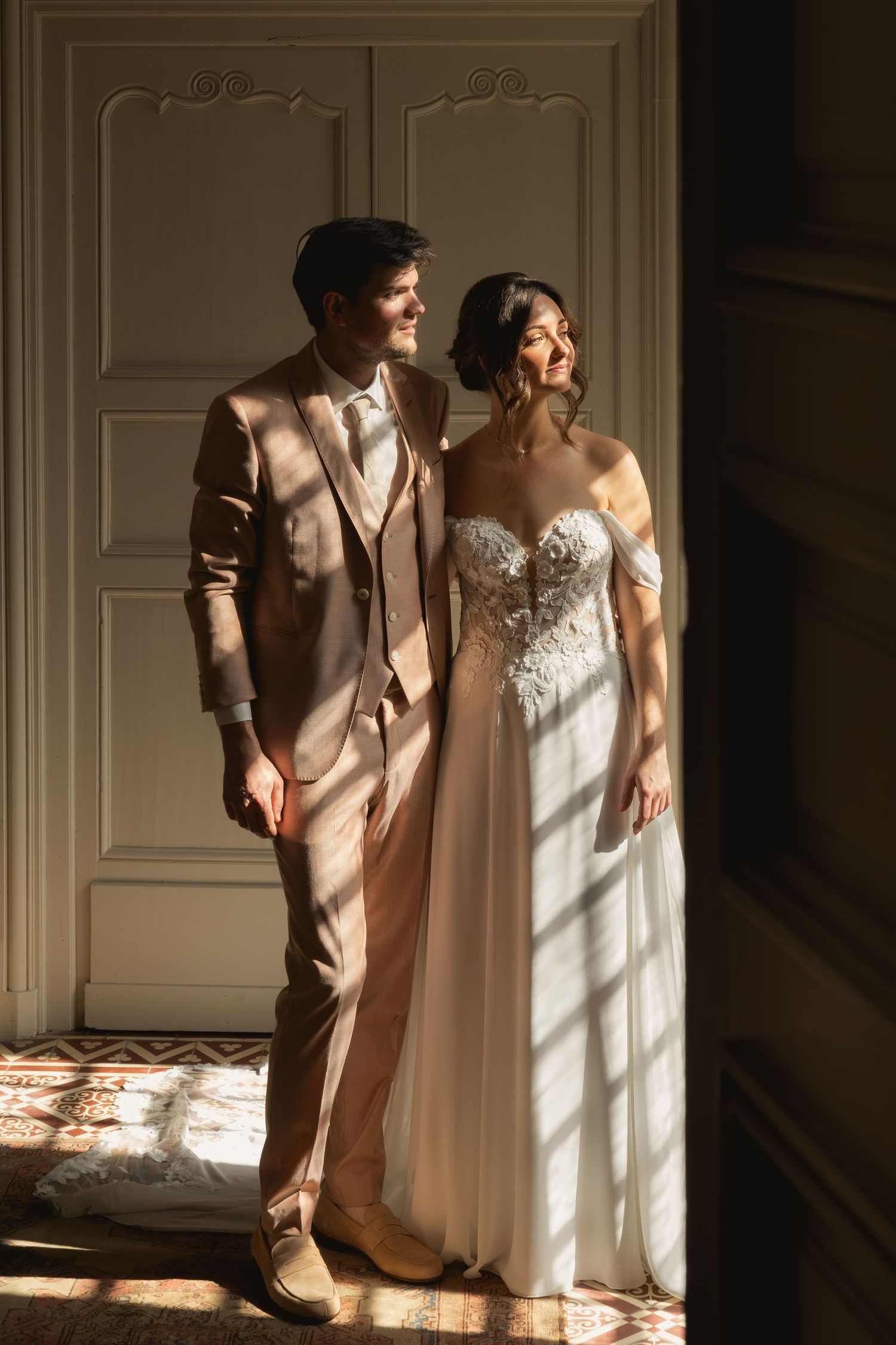 Bride and groom portrait inside the abbey illuminated by soft natural morning light