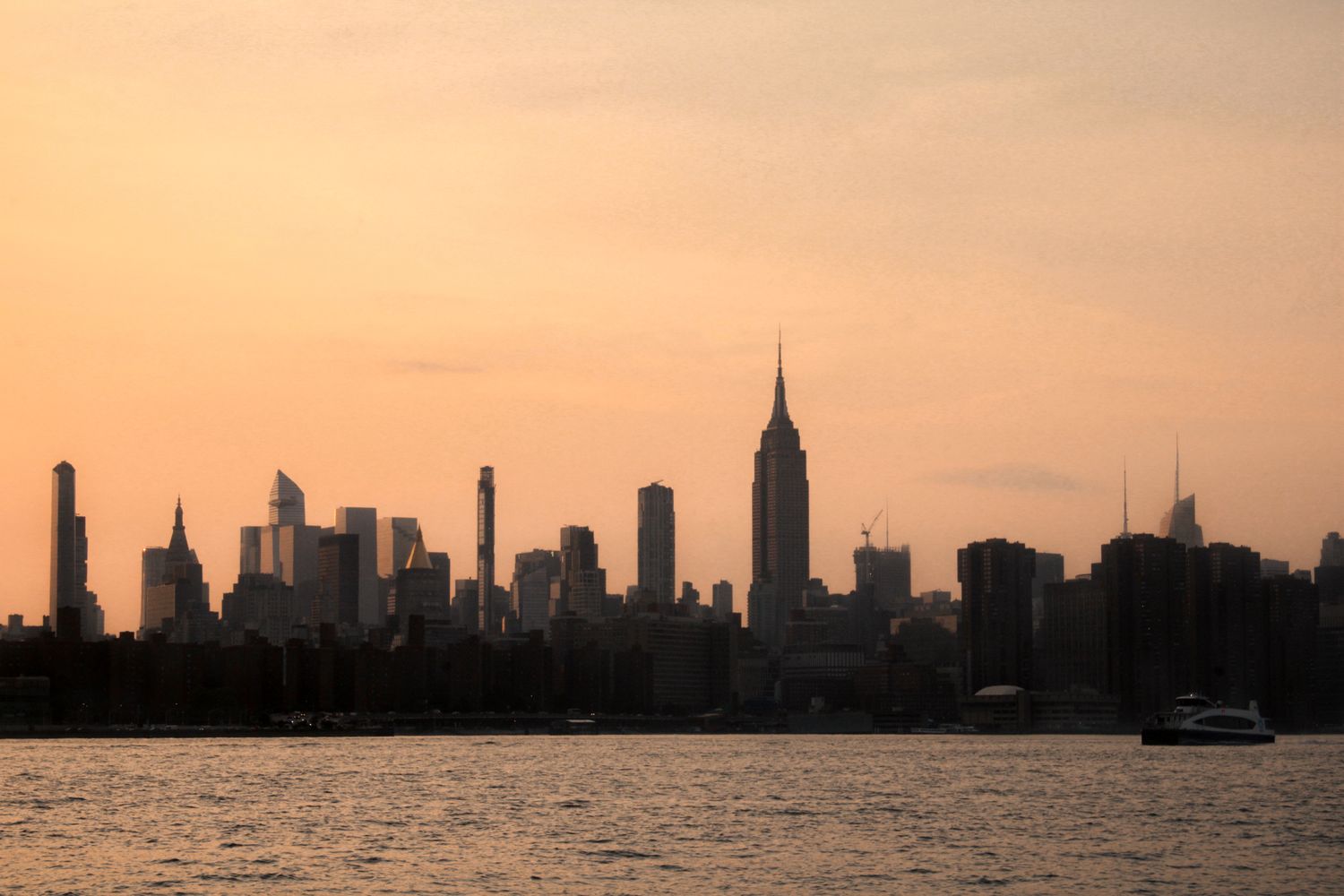 Soft pastel sunset over the Manhattan skyline and Empire State Building from Brooklyn, New York City