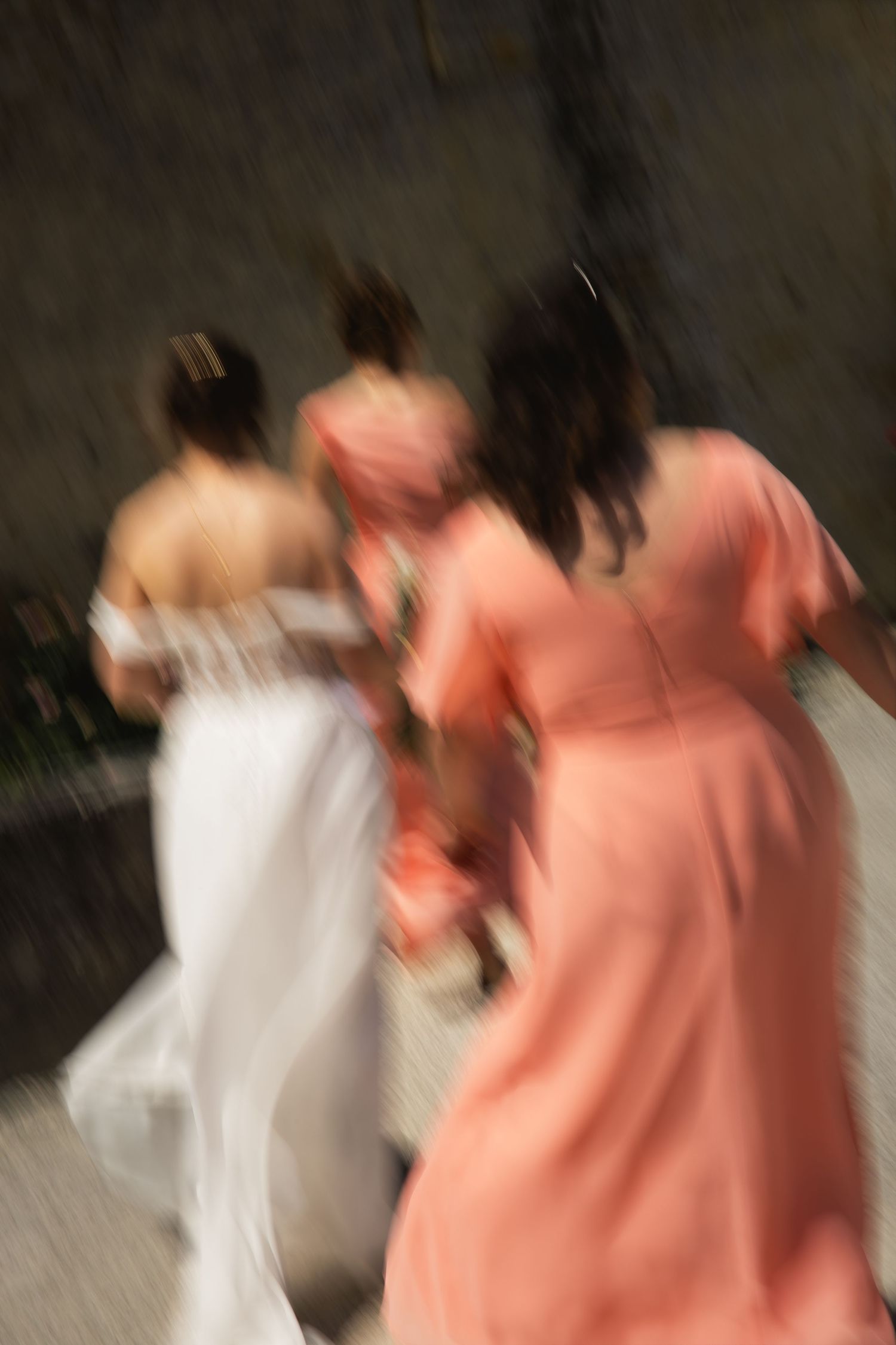 Bride and her bridesmaids running together with artistic motion blur