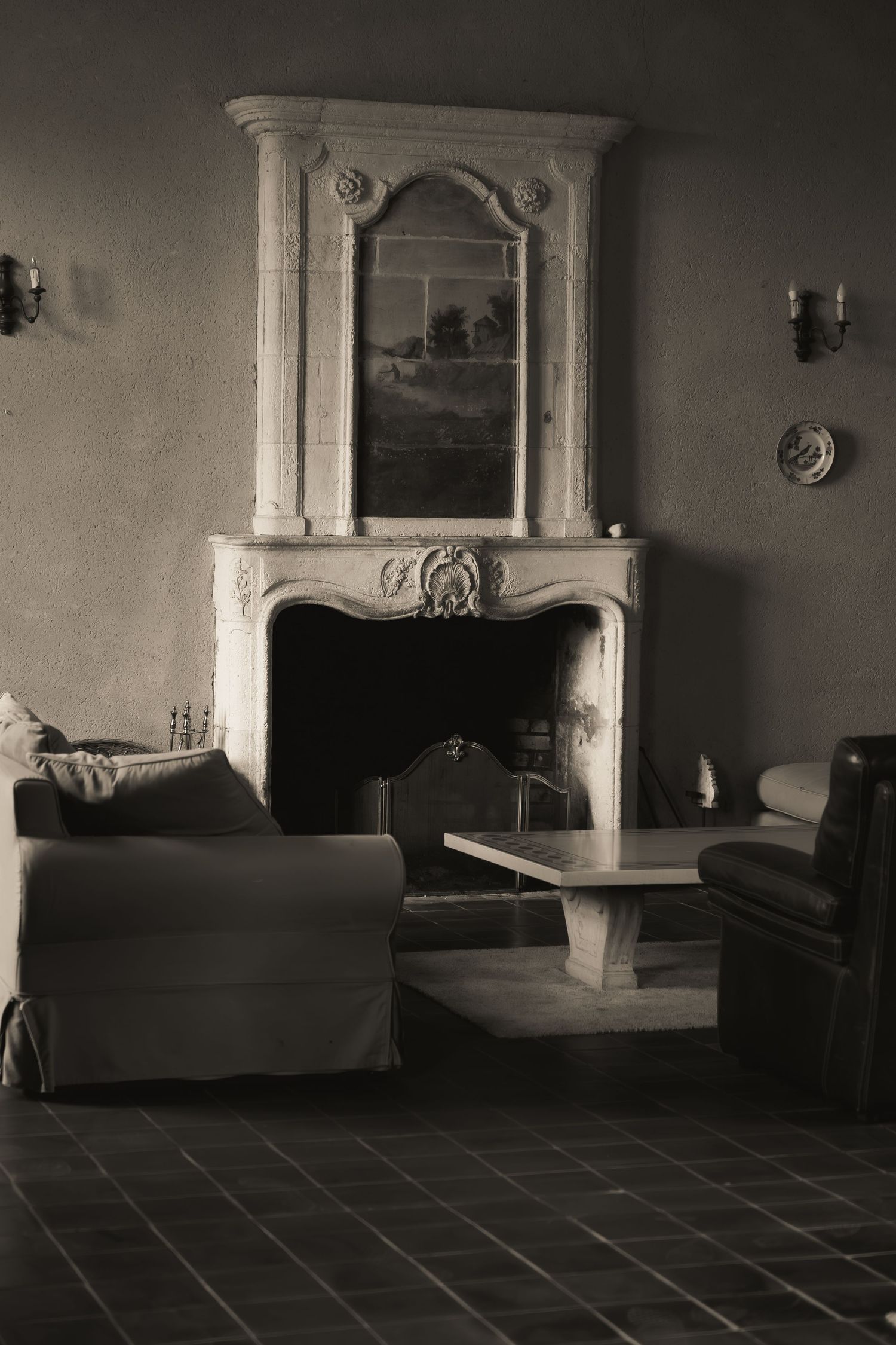 Elegant fireplace in the wedding venue's salon, photographed in timeless black and white.