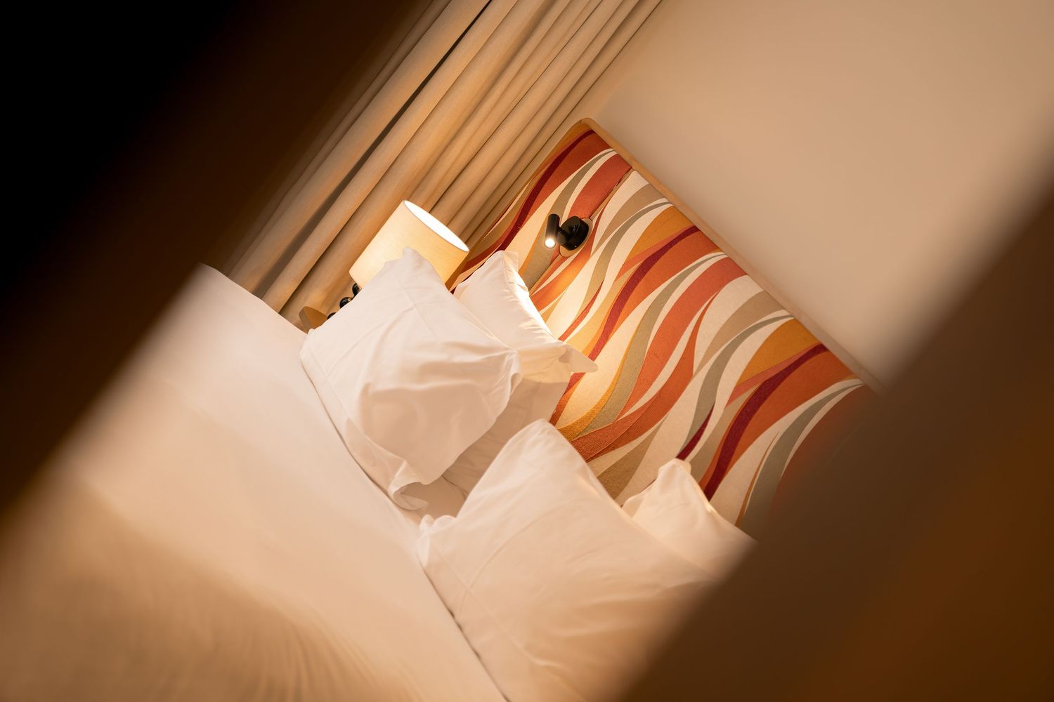 Elegant hotel room with a king-size bed at Hôtel Padam in Paris
