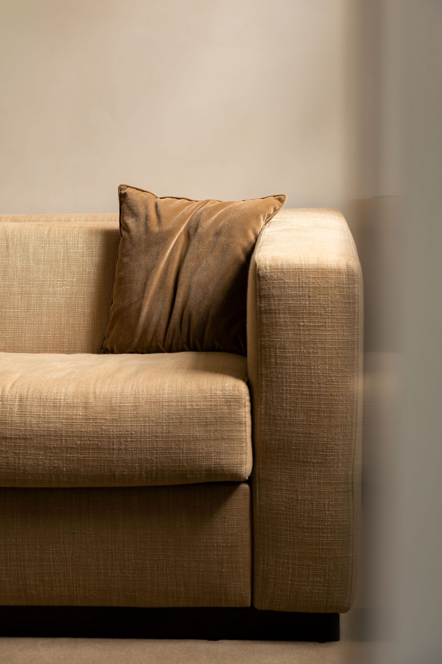 Warm-toned living room interior with a textured sofa at Mondovi Luxury Suites in Paris