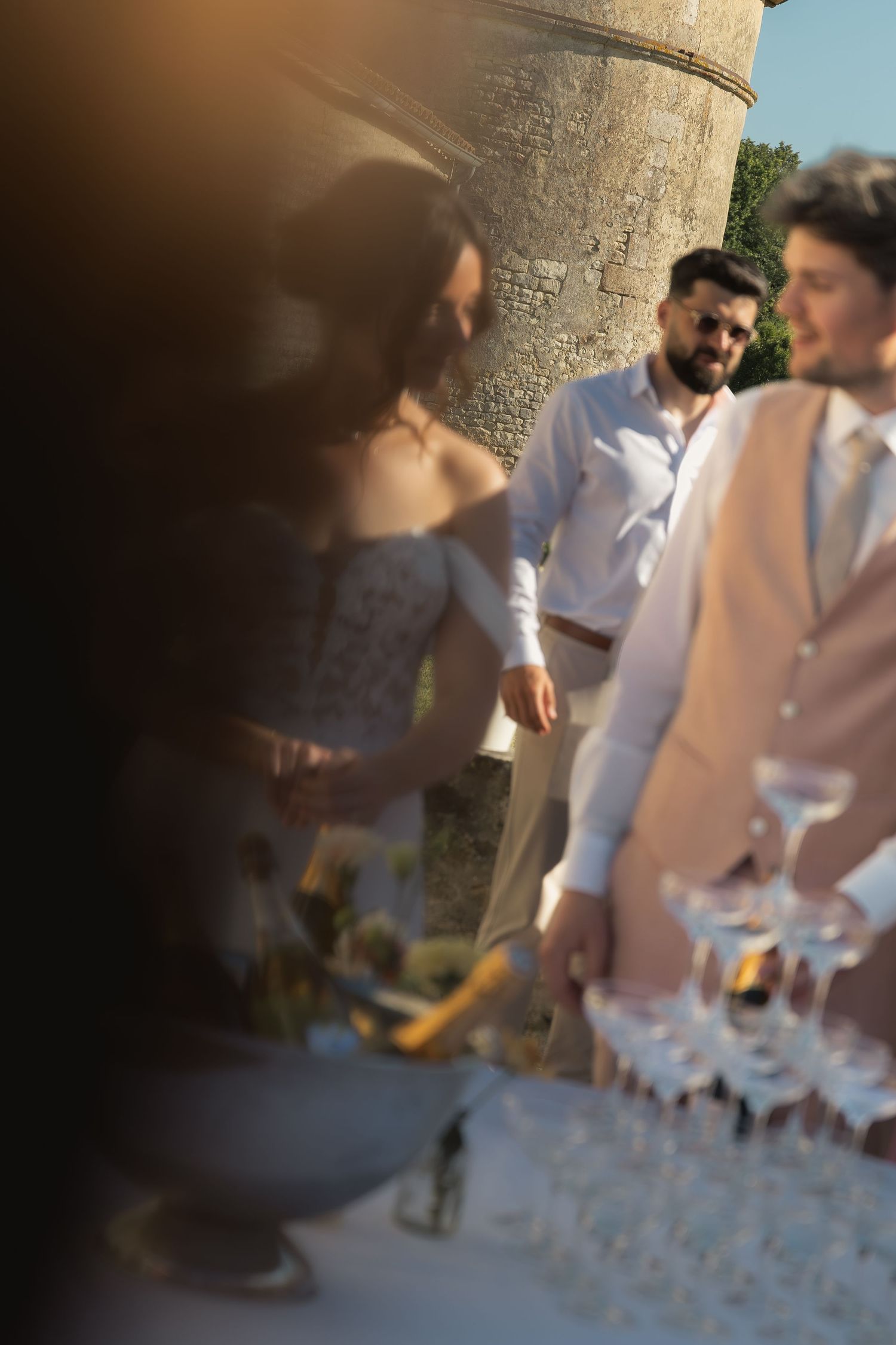 Bride and groom posing together in front of a champagne tower