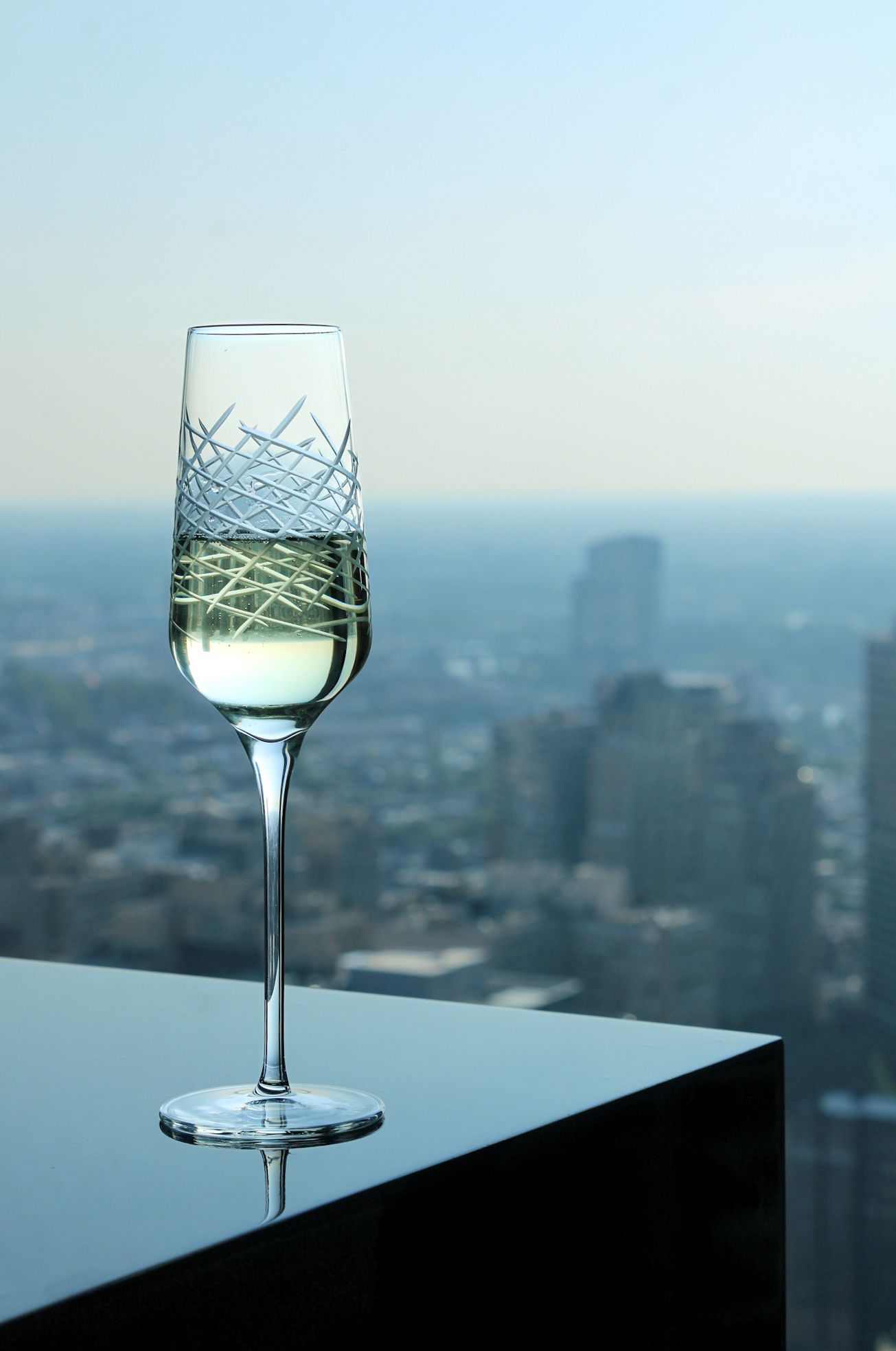 Champagne glass overlooking the Philadelphia skyline from a luxury suite at W Philadelphia