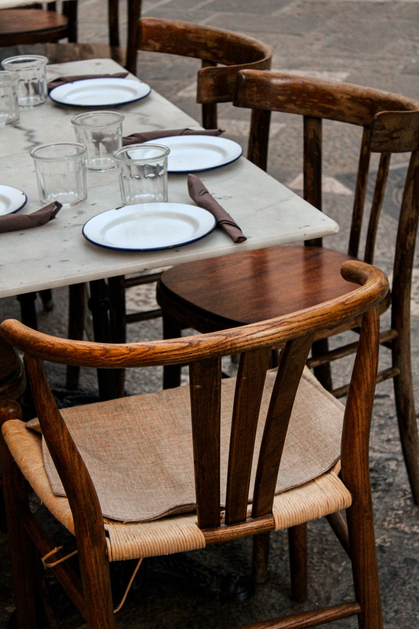 Wooden table beautifully set for an outdoor dinner in Lecce, Puglia