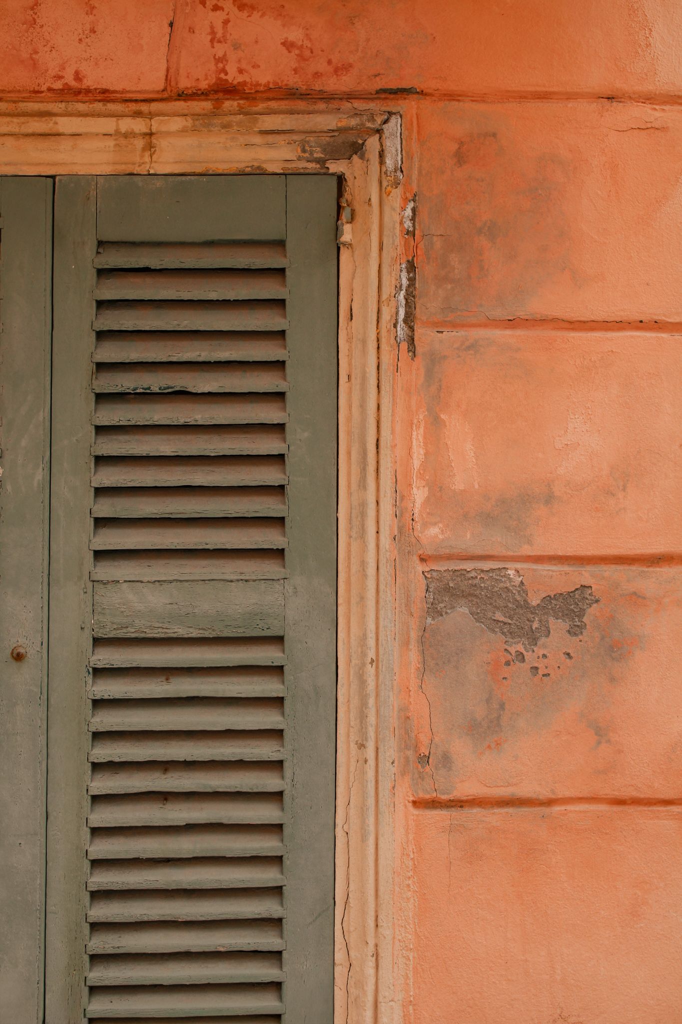 Colorful house facade with green shutters and orange wall in Saint-Tropez, South of France
