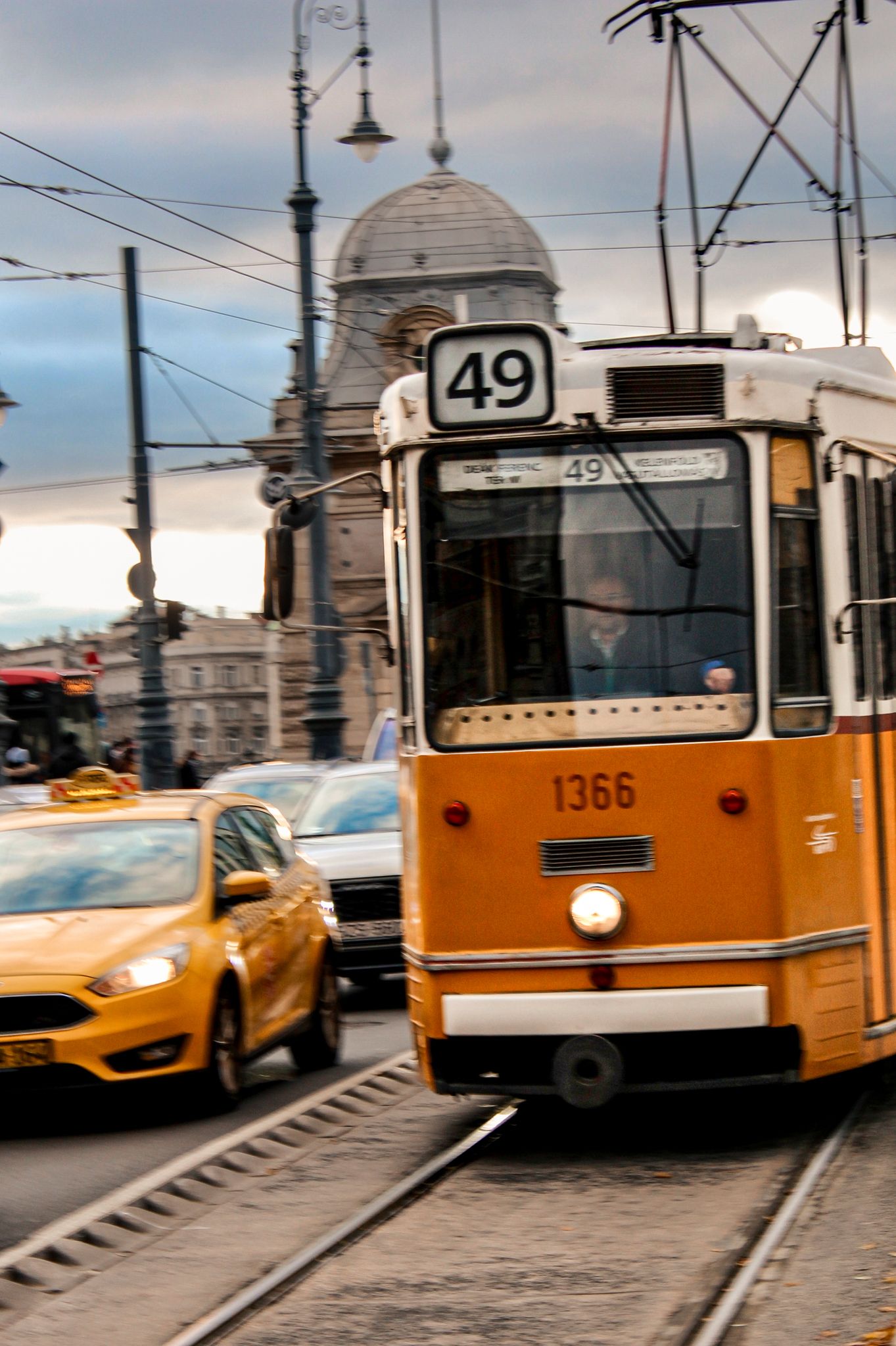 Iconic yellow tram traveling through the streets of Budapest