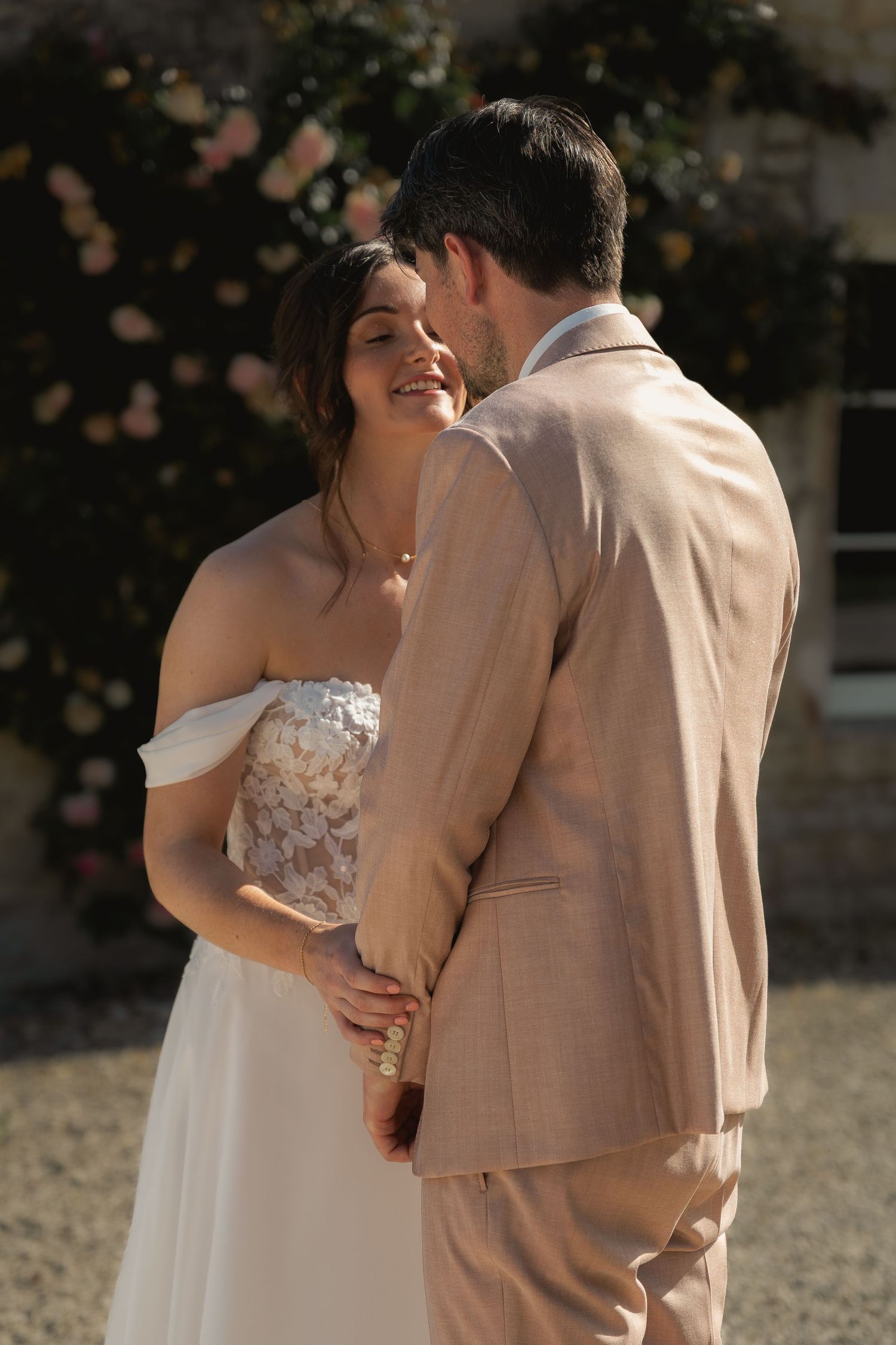 Bride and groom embracing after their first look before sharing a kiss