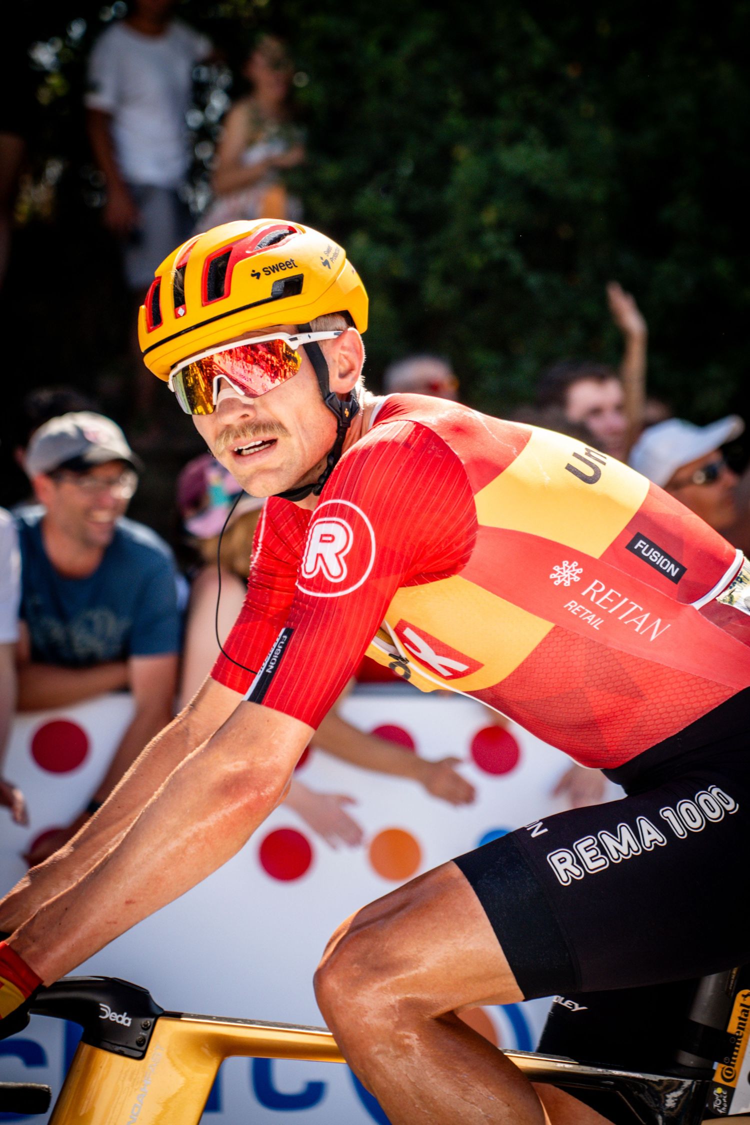 Action photography of cyclists during the Tour de France, motion, energy and determination in a dynamic sports atmosphere.