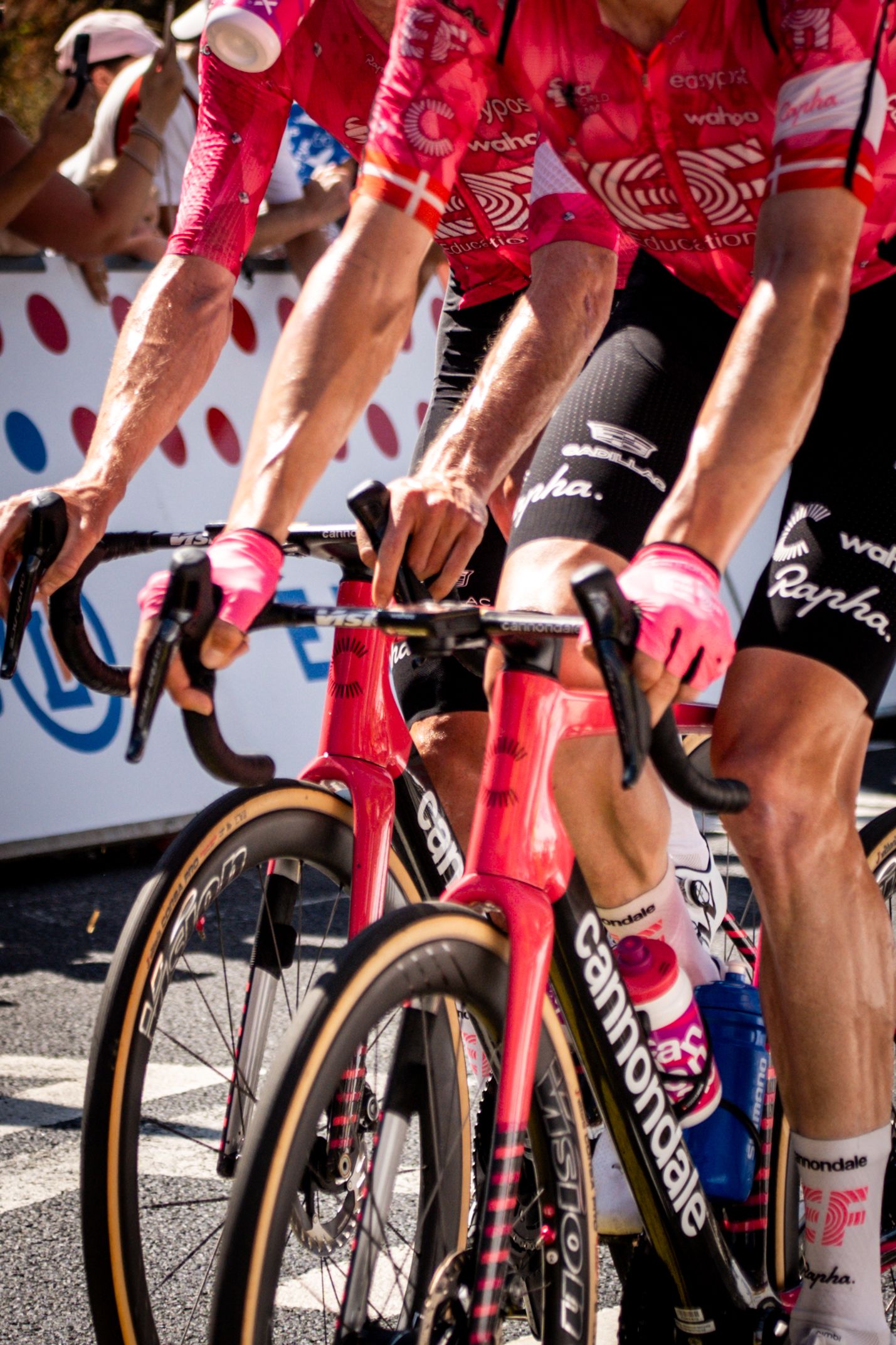 Action photography of cyclists during the Tour de France, motion, energy and determination in a dynamic sports atmosphere.