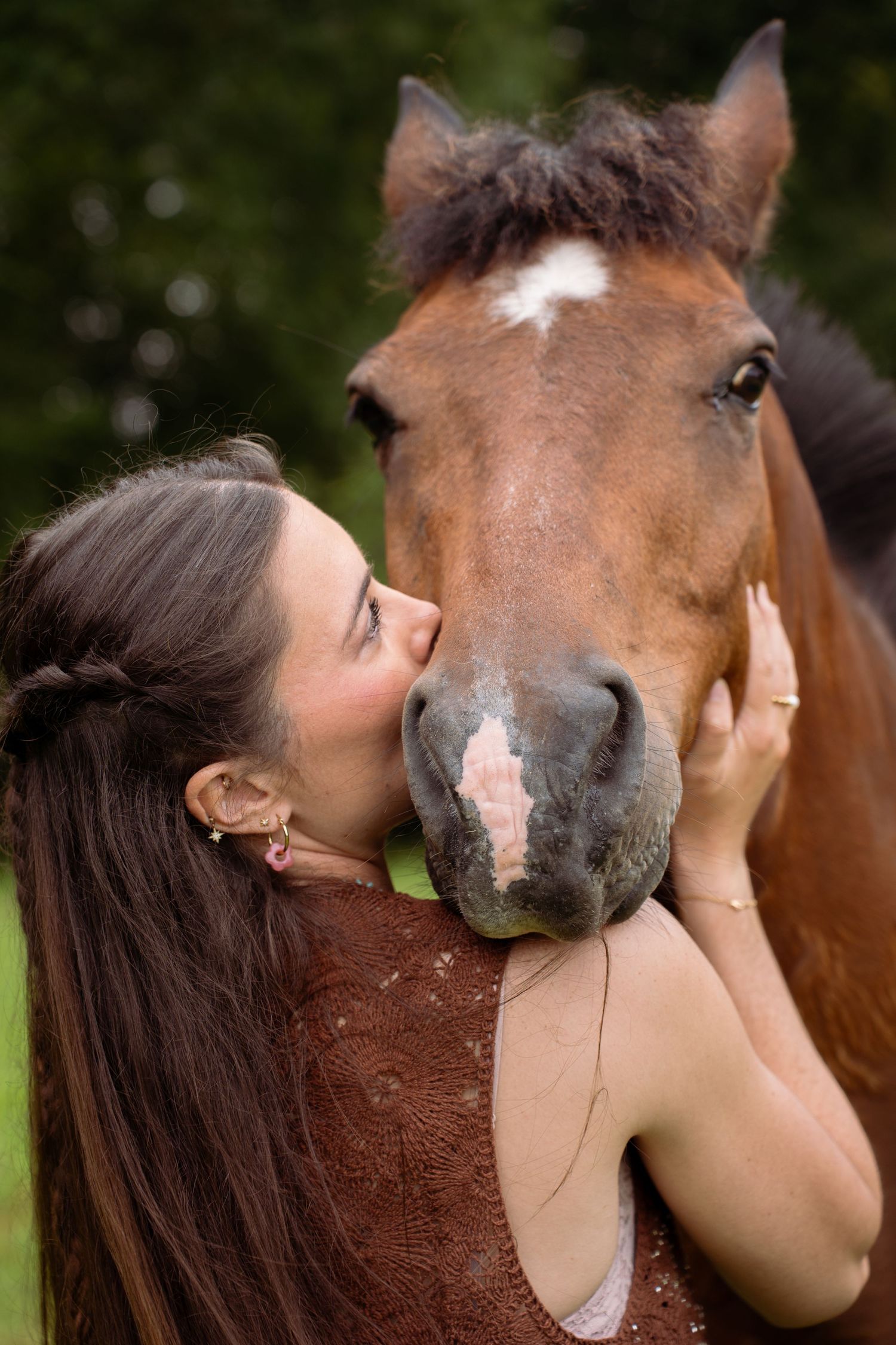 Young woman with her horse in natural landscape, soft light, authentic connection between human and animal, peaceful and emotional atmospher