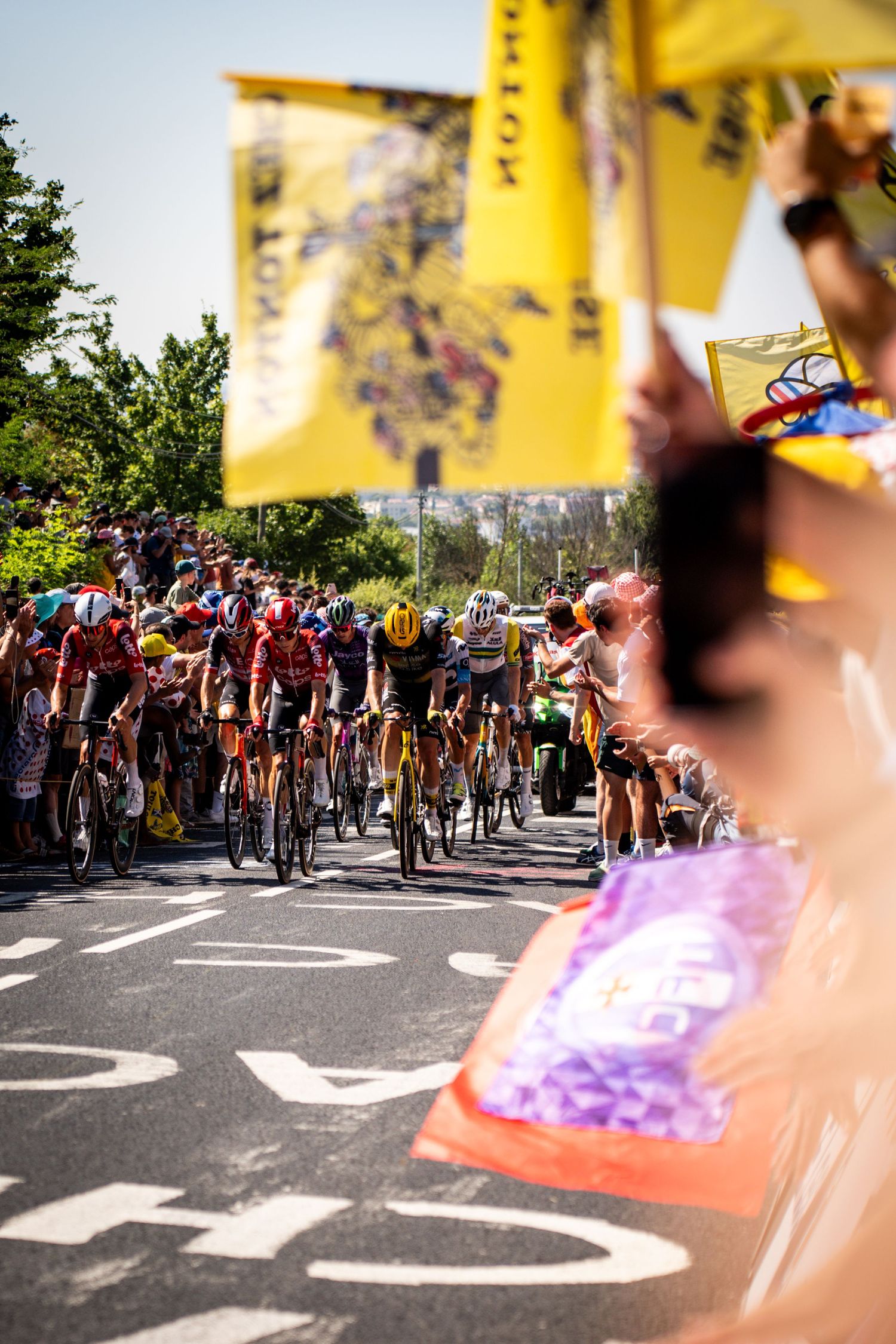 Action photography of cyclists during the Tour de France, motion, energy and determination in a dynamic sports atmosphere.