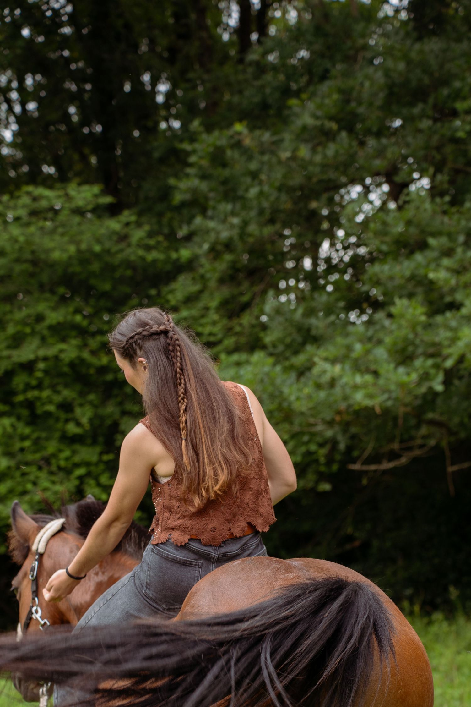 Young woman with her horse in natural landscape, soft light, authentic connection between human and animal, peaceful and emotional atmospher
