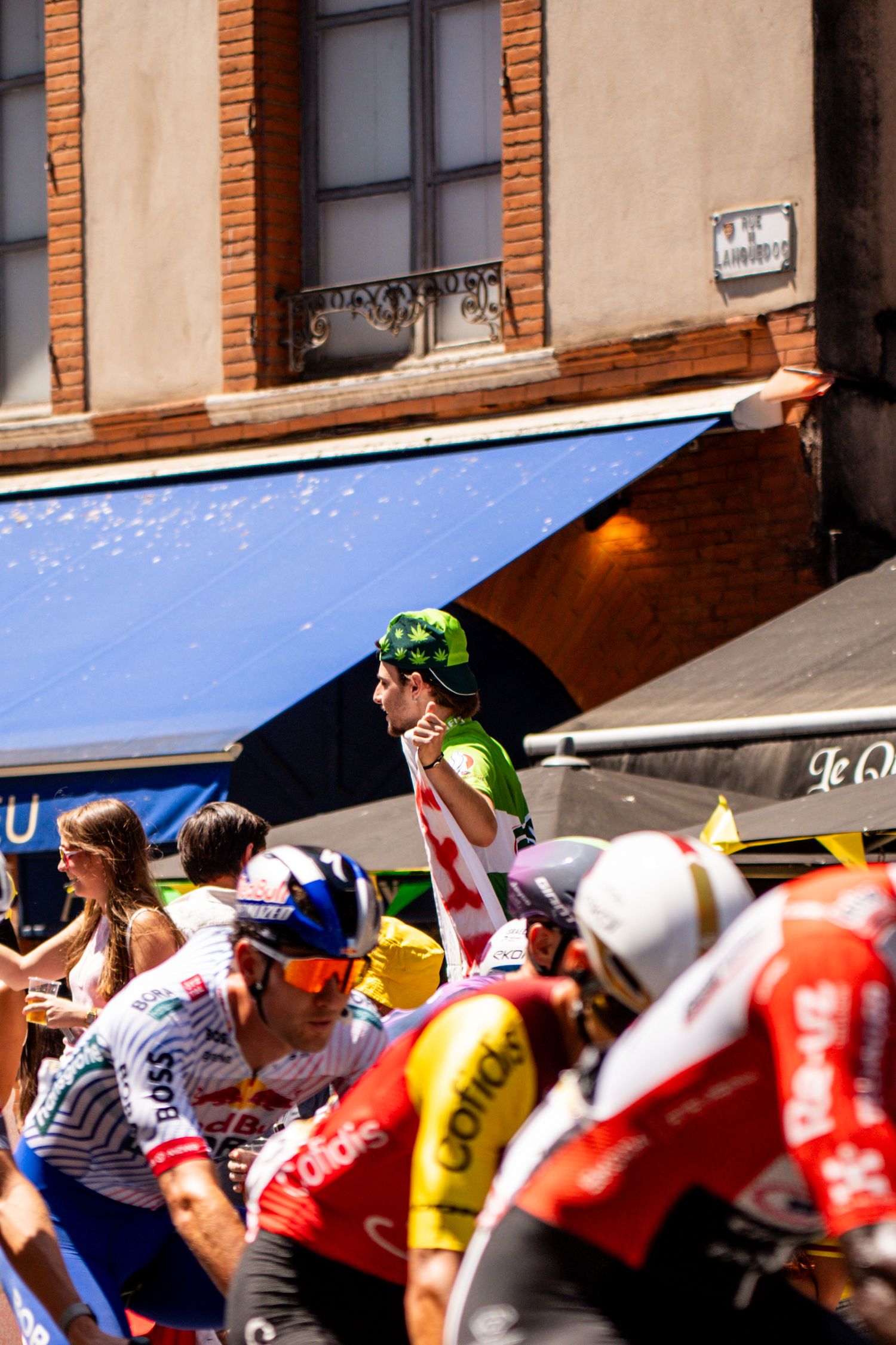 Action photography of cyclists during the Tour de France, motion, energy and determination in a dynamic sports atmosphere.