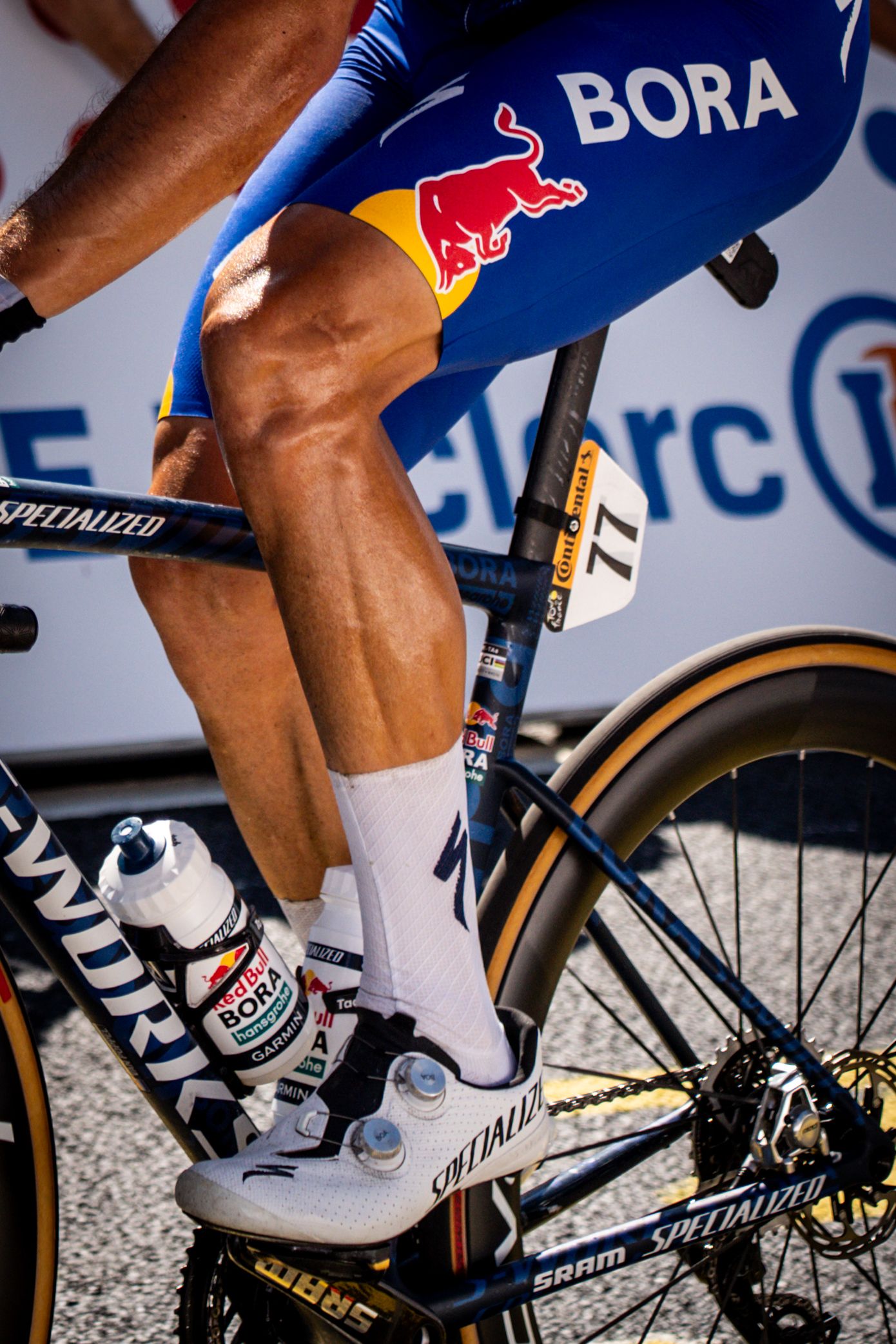 Action photography of cyclists during the Tour de France, motion, energy and determination in a dynamic sports atmosphere.