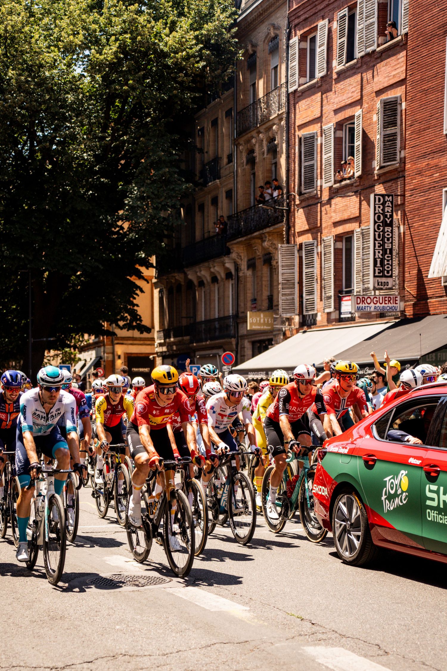 Action photography of cyclists during the Tour de France, motion, energy and determination in a dynamic sports atmosphere.