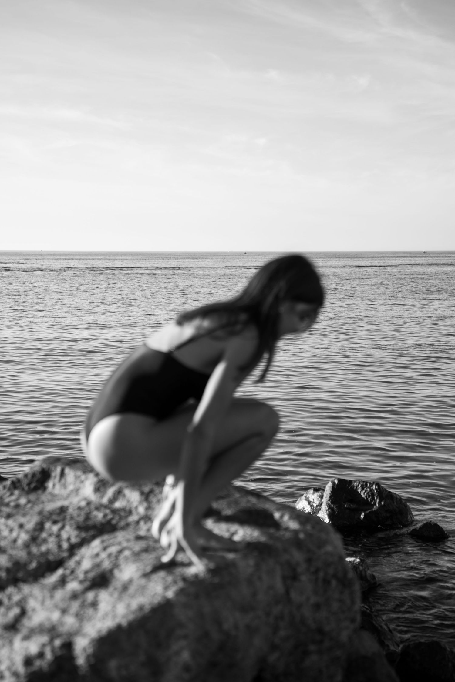 Portrait of a woman on the beach in warm natural light, with ocean and soft tones creating a cinematic mood.