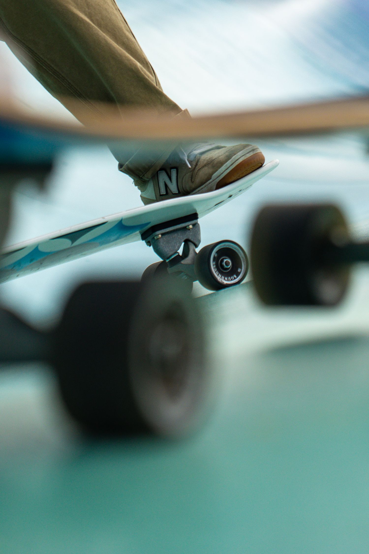 Skateboard competition on the beach, athletes performing tricks with ocean in the background, dynamic movement and vibrant summer atmosphere