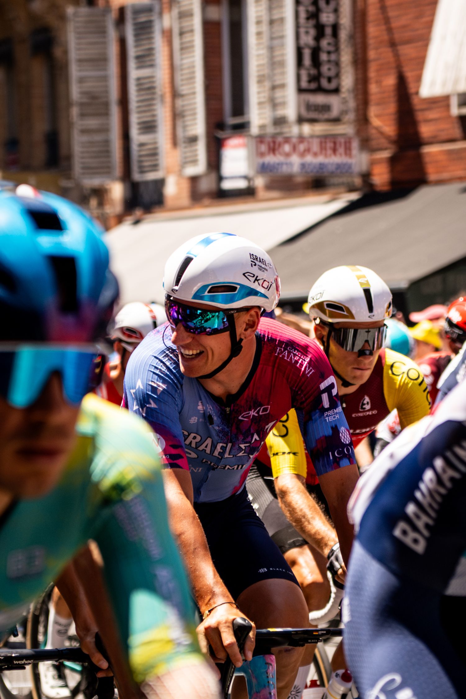 Action photography of cyclists during the Tour de France, motion, energy and determination in a dynamic sports atmosphere.