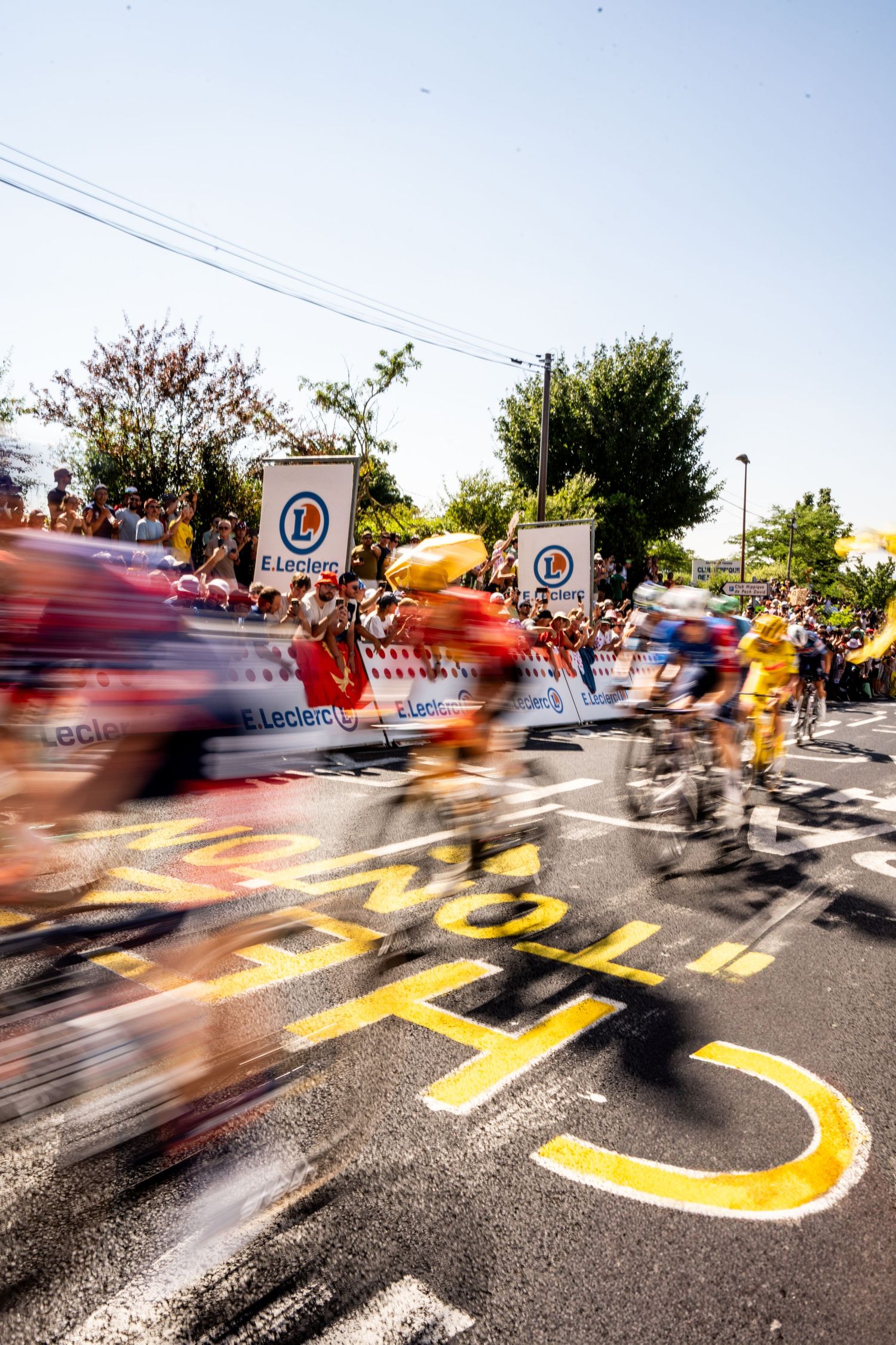 Action photography of cyclists during the Tour de France, motion, energy and determination in a dynamic sports atmosphere.