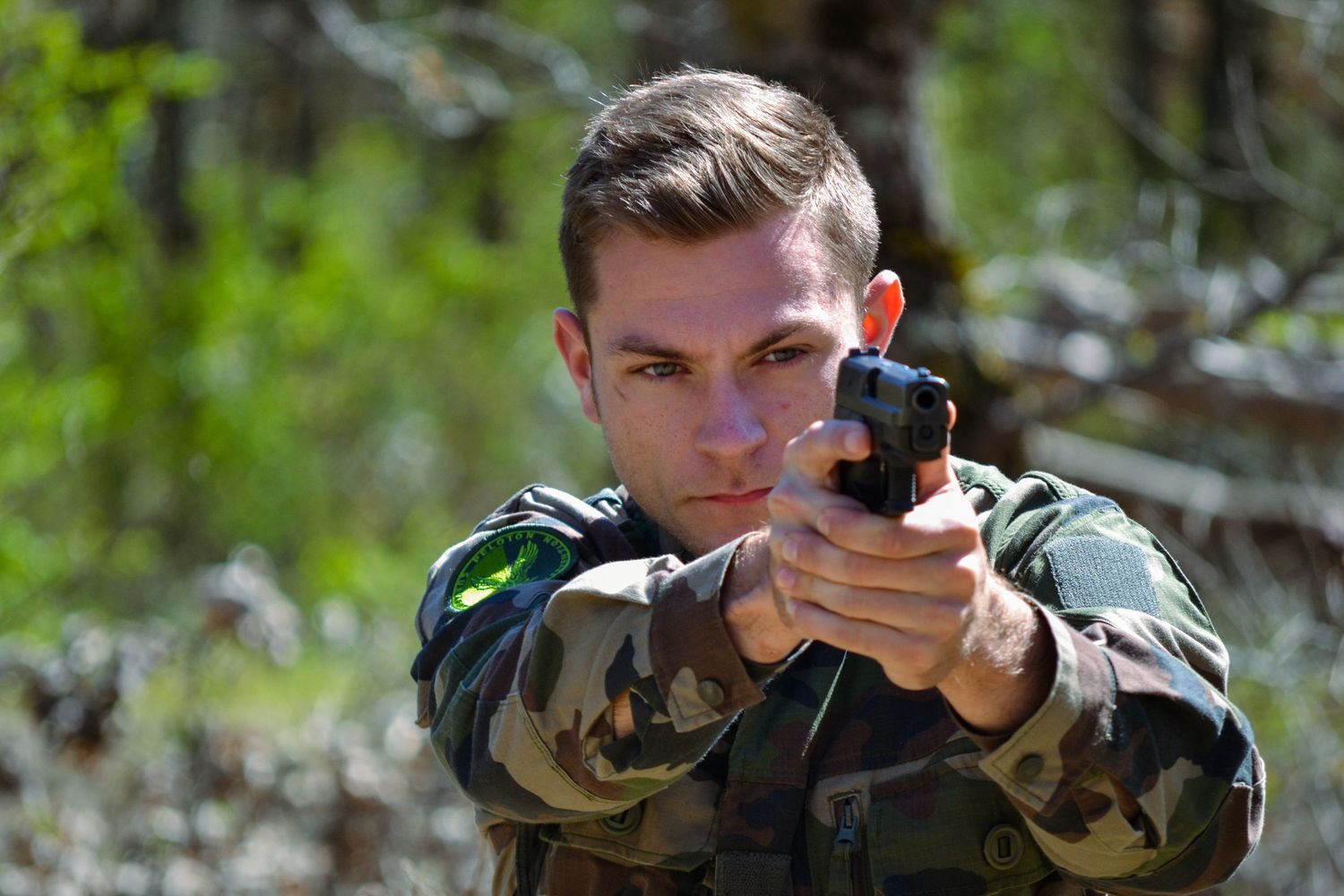 Professional photography of gendarmerie officers during training exercise, dynamic action, teamwork and intensity captured in natural light.