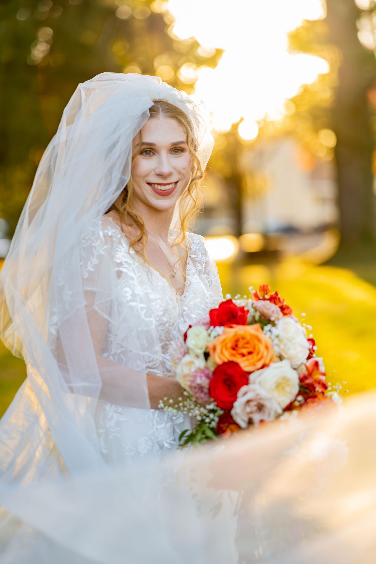 Beautiful bridal portrait series at sunset with orange and white bouquet against golden sunlit background.