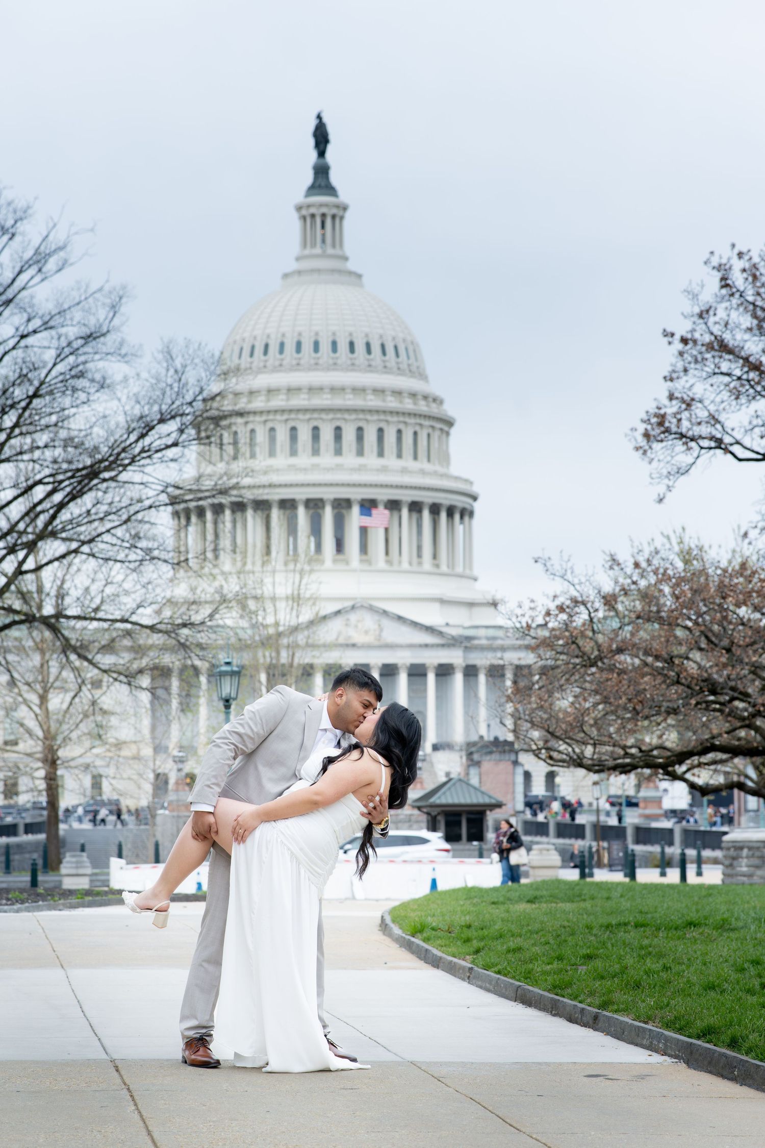 Couple sharing a romantic dip kiss in front of the US Capitol building in Washington DC.