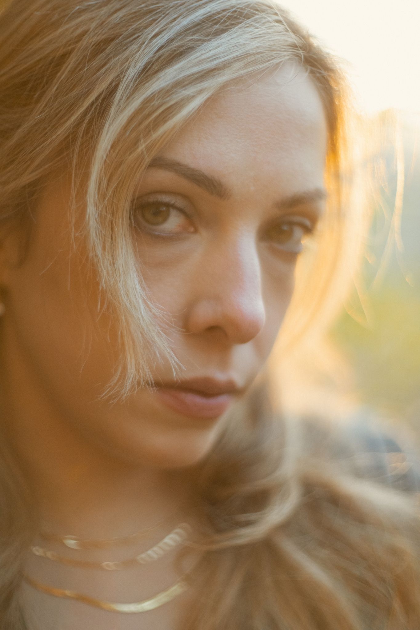 Soft focus portrait with warm sunlight creating a dreamy atmosphere.