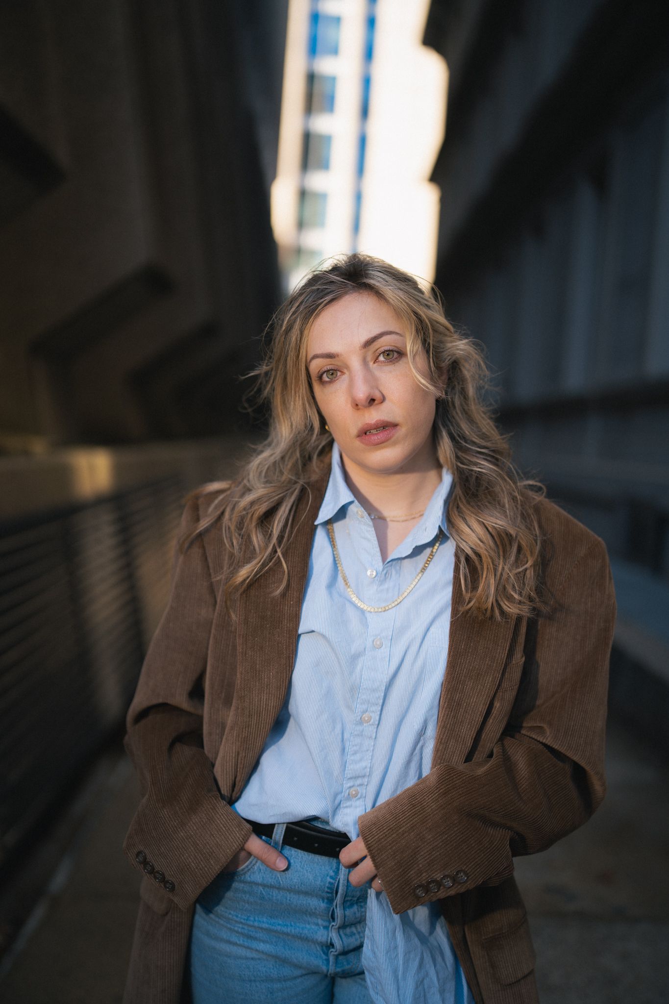 A sequence of moody indoor portrait shots featuring casual business attire and dramatic lighting.