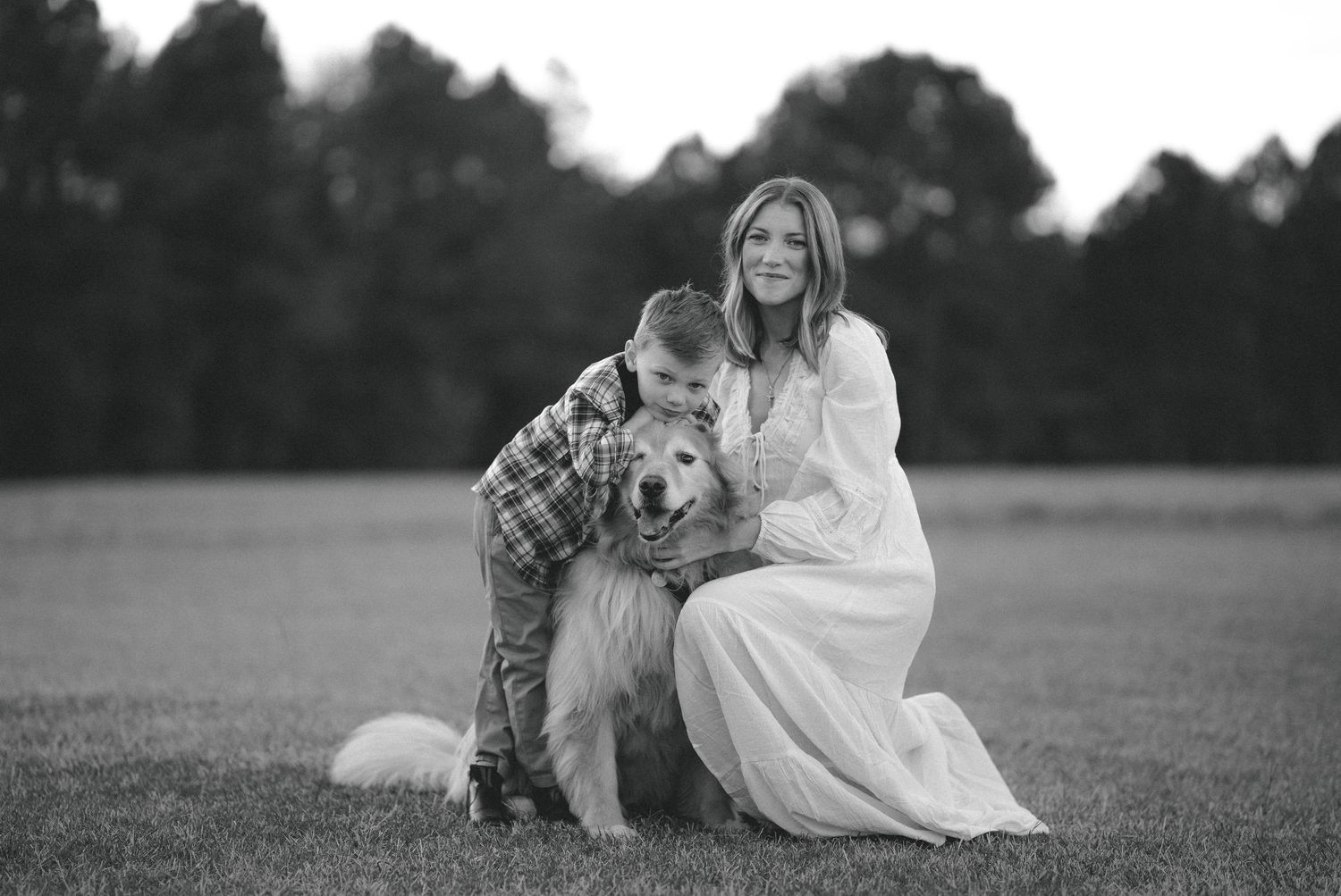 A series of black and white photos showing people in casual poses outdoors in a grassy field.
