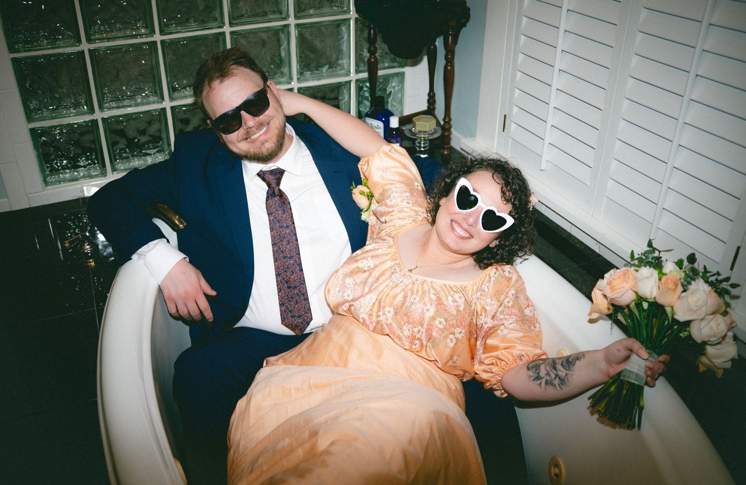Wedding party celebrates indoors with joyful dancing and candid moments.