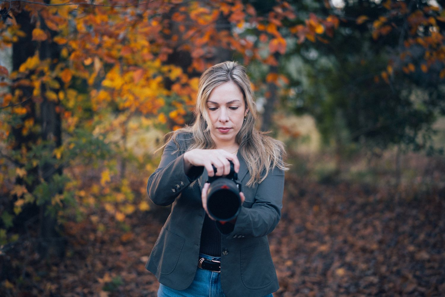 A romantic autumn photoshoot in a park with golden leaves and natural lighting.