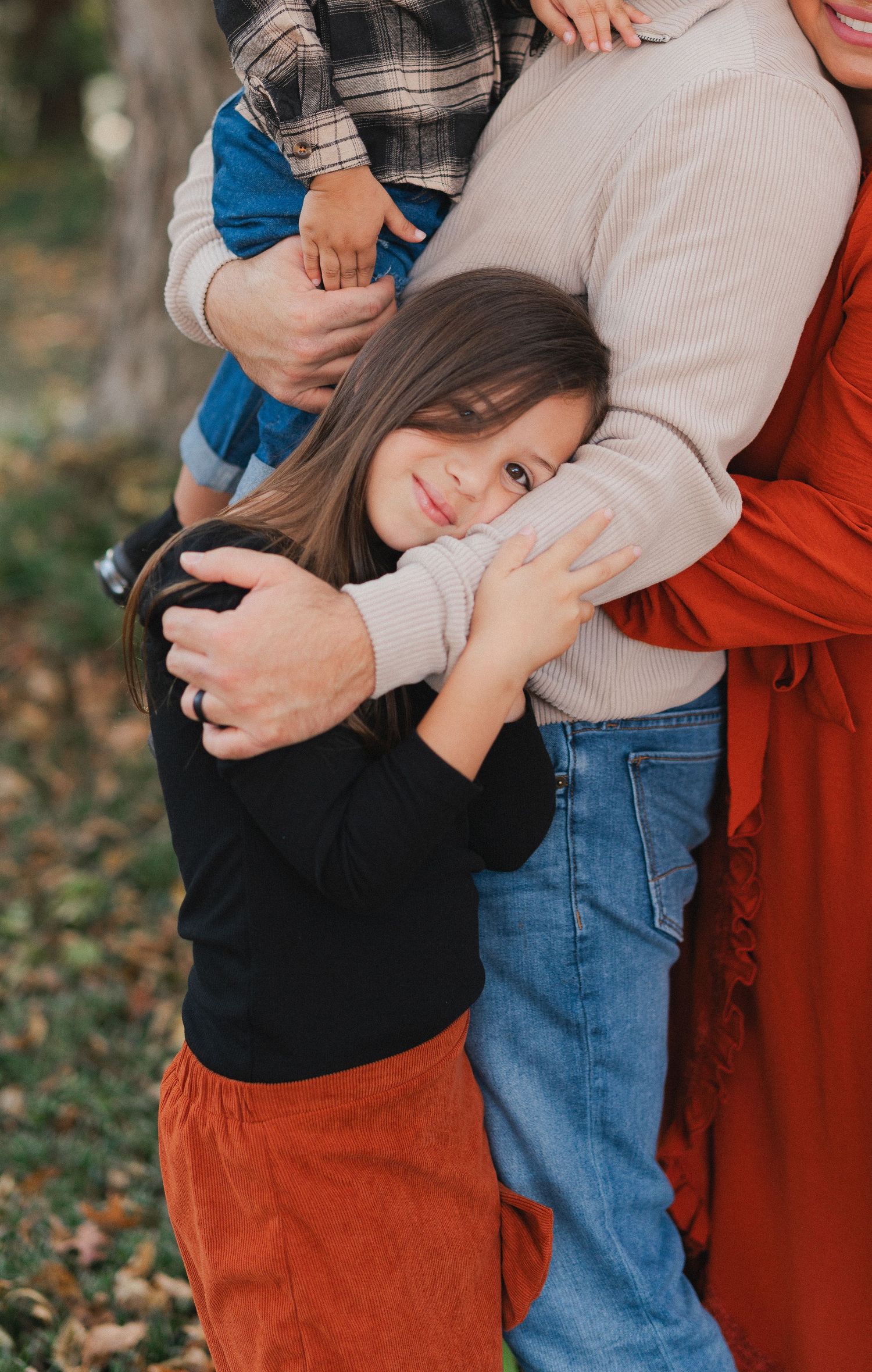 Tender family moment captured in fall with warm autumn colors and embraces.